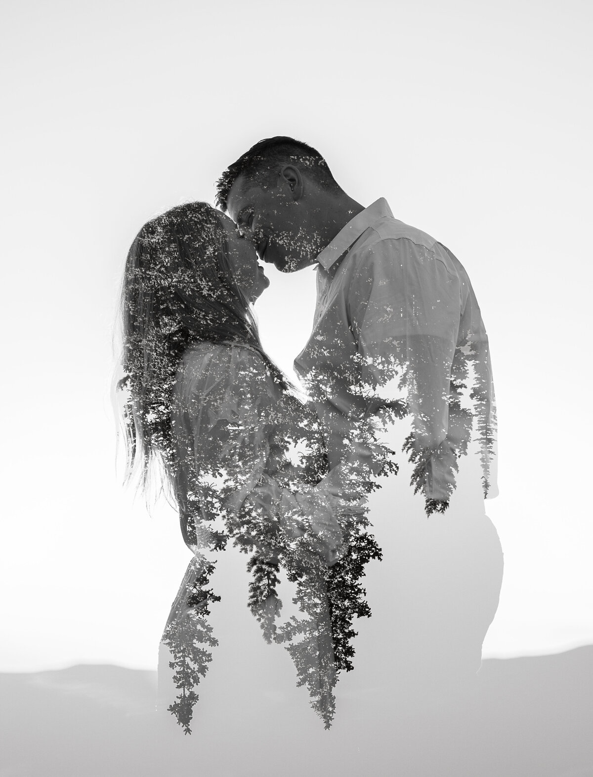 Double exposure of couple kissing and trees