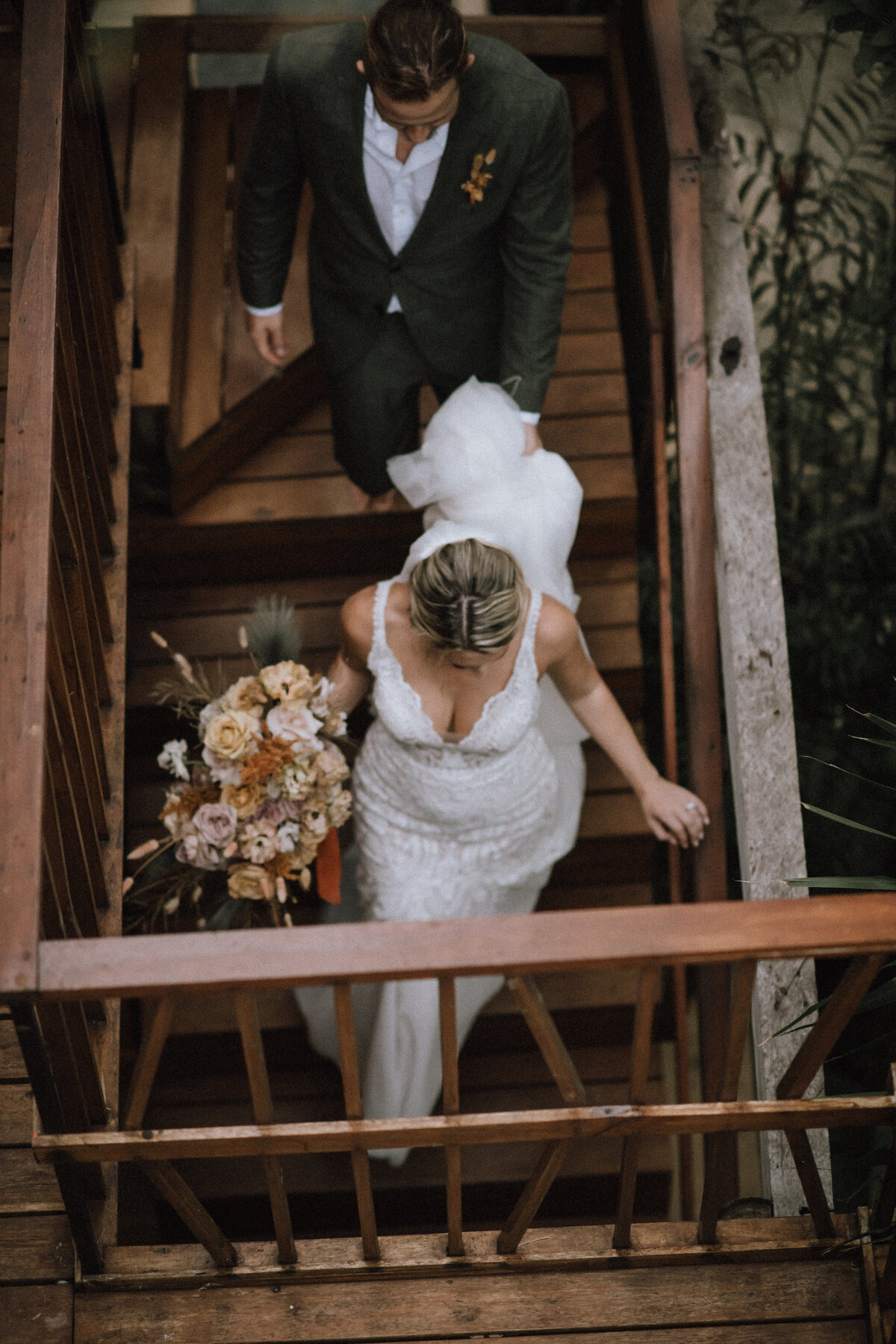 Bride and groom walk down the stairs at Villa Amaite during their destination wedding in Tulum Mexico.