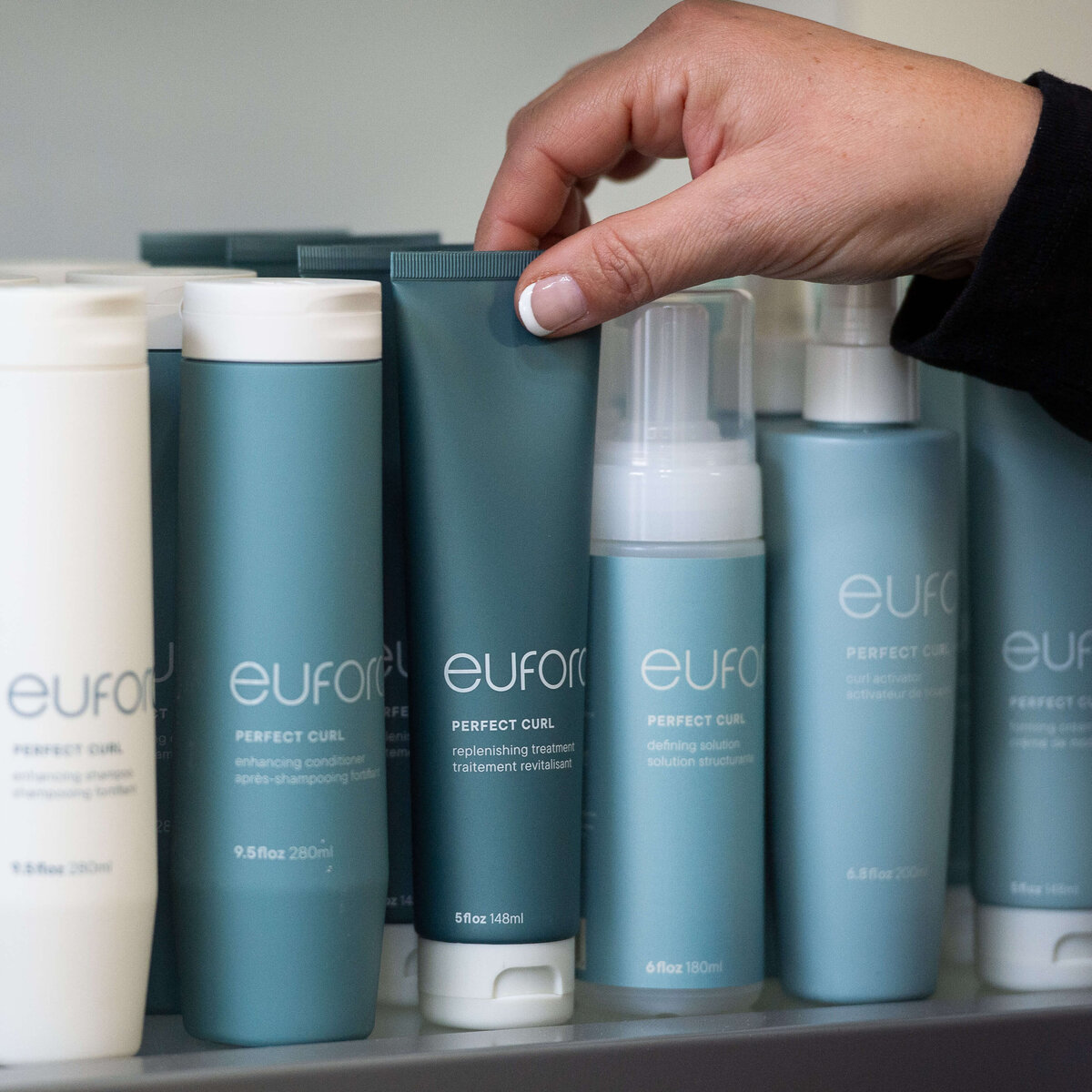 Ottawa branding photos of hair products in green containers on the shelves of Richardson Hair Design.  Captured by JEMMAN Photography