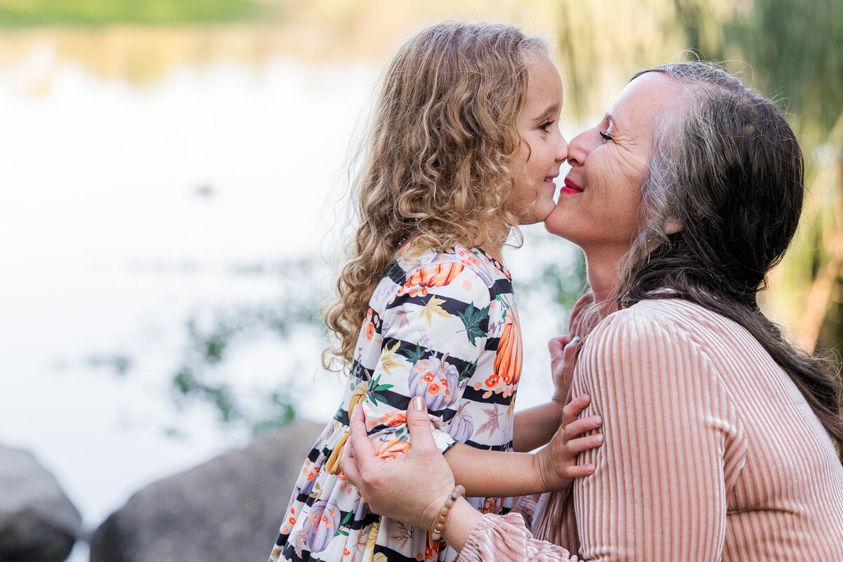 grandmother kissing granddaughter
