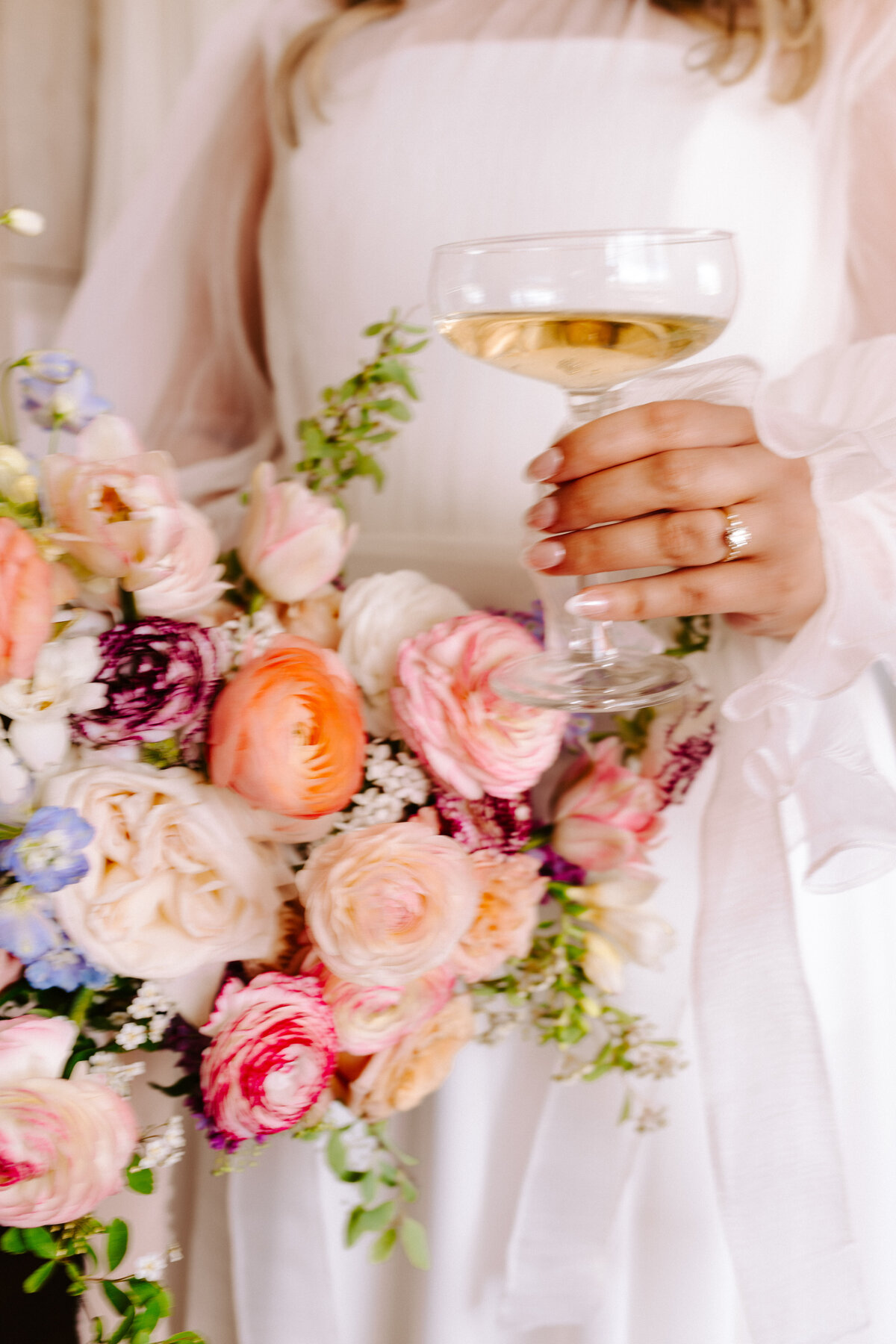 Bridal bouquet detail shot, with the bride holding a glass of wine at the Grand Ivory near Moncton, New Brunswick