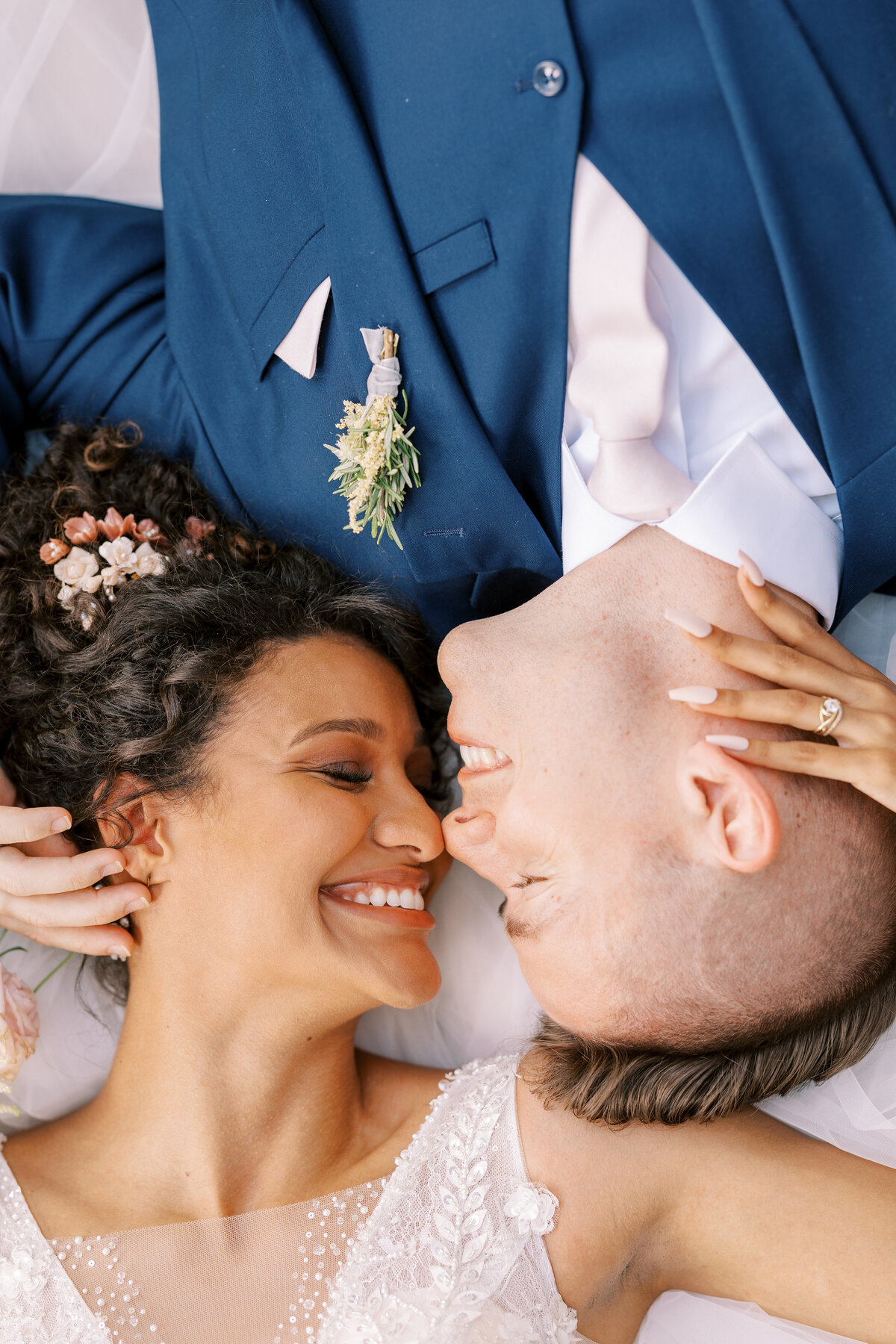 aerial closeup image of bride and groom smiling with eyes closed
