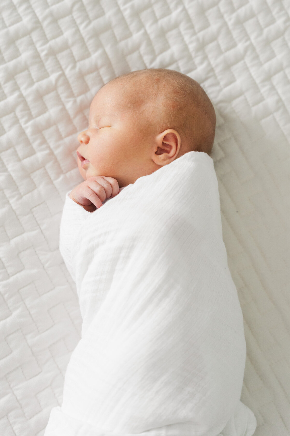 Minneapolis newborn photographer highlights the delicate beauty of a sleeping baby