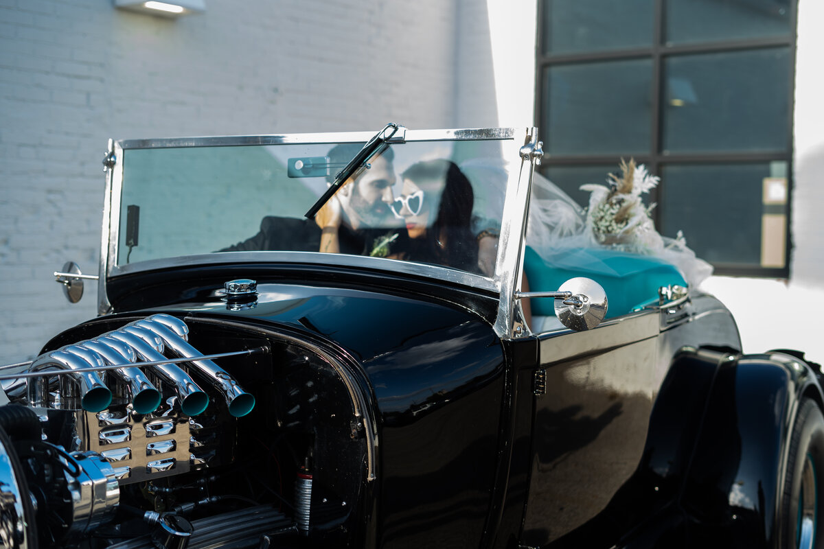 couple editorial pose in vintage car at The Madison in Cleveland