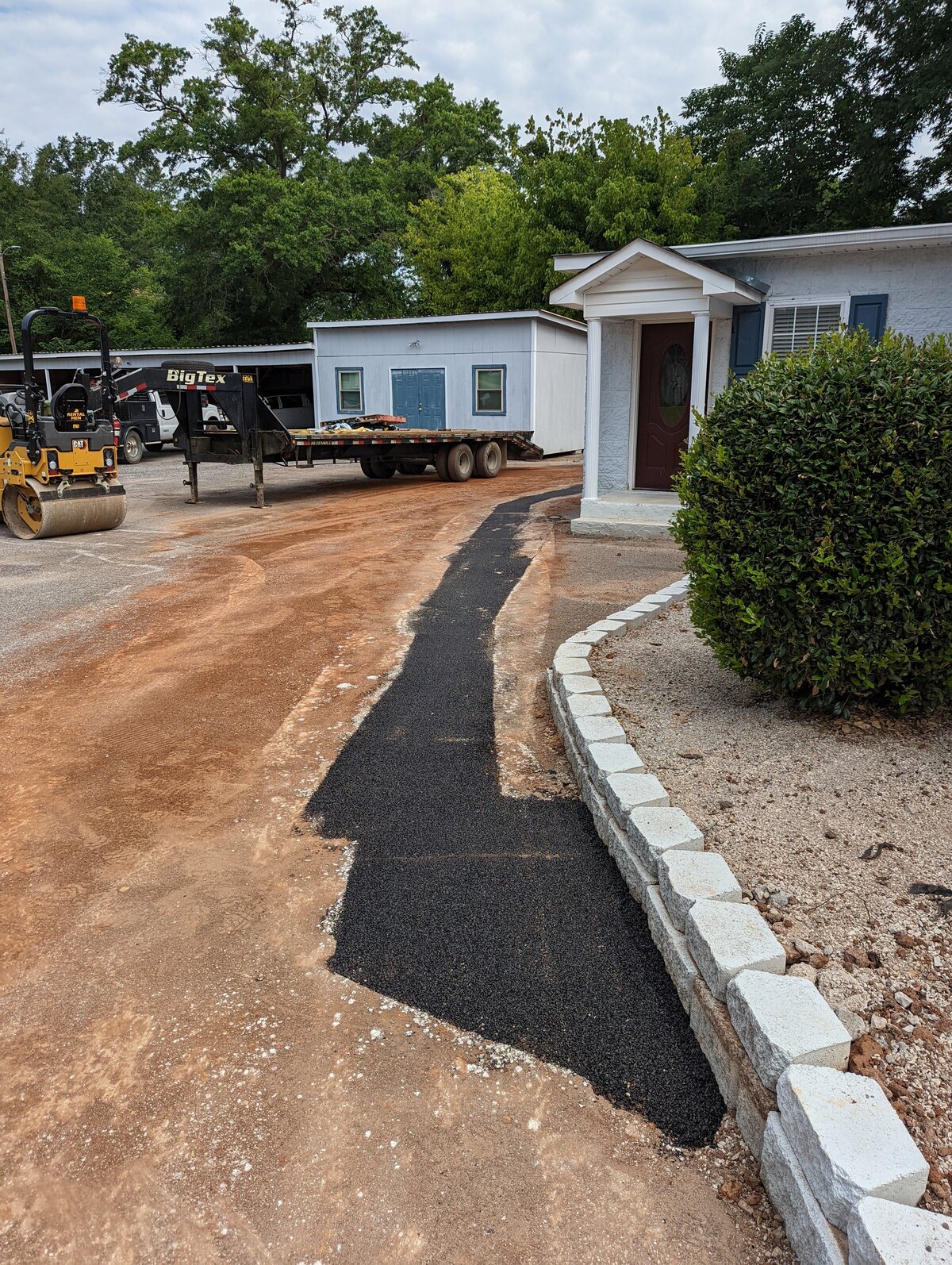 black-asphalt-path-outside-white-building