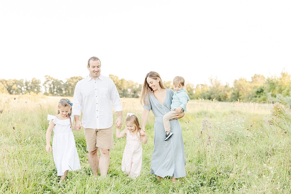 familuy walks holding hands duirng fall family photo session with Sara Sniderman Photography in Natick Massachusetts