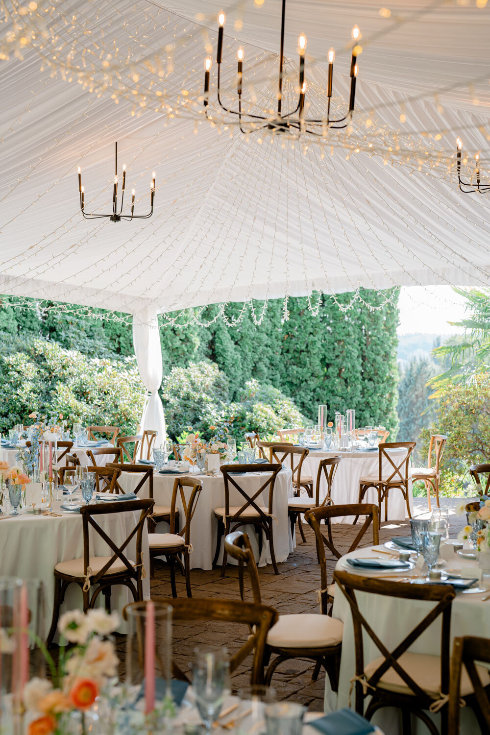 Elegant outdoor dining under a draped tent