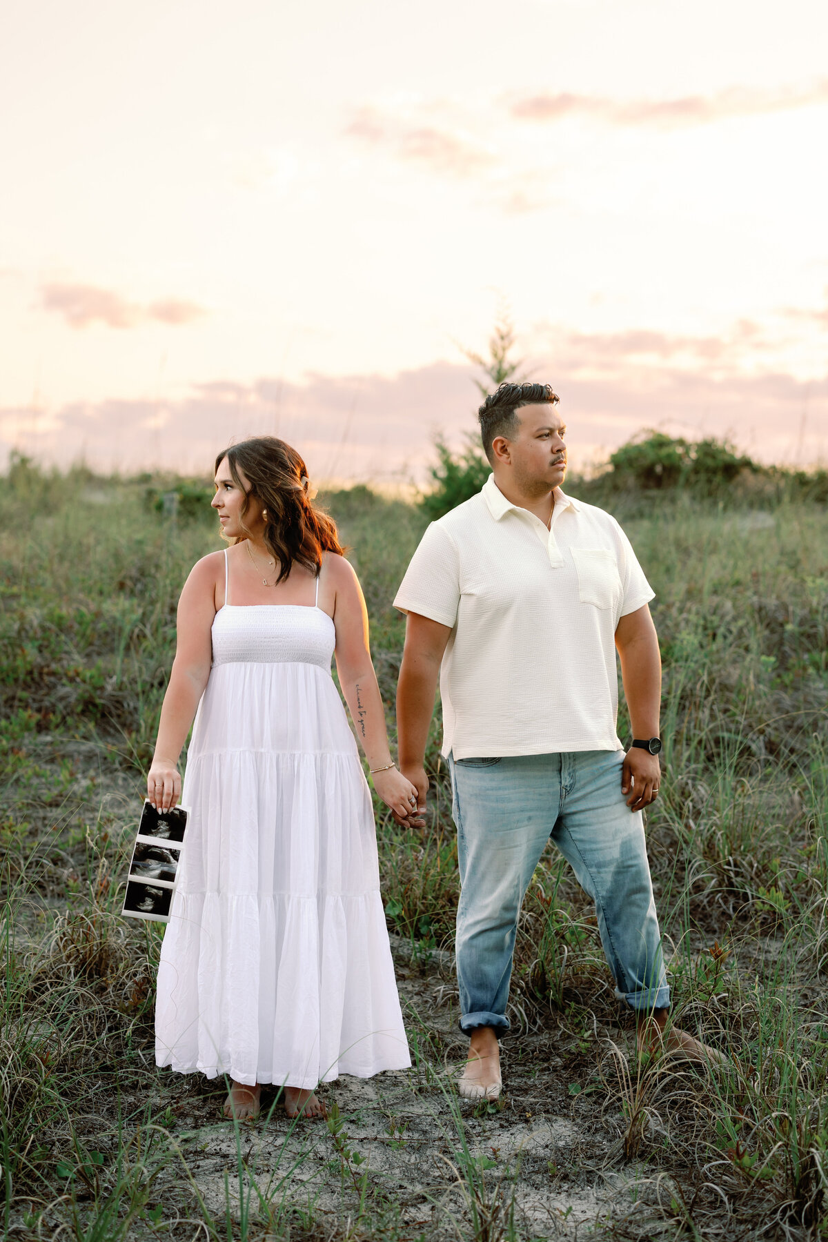 Pregnant woman holding her baby photos, serene Wilmington maternity photography
