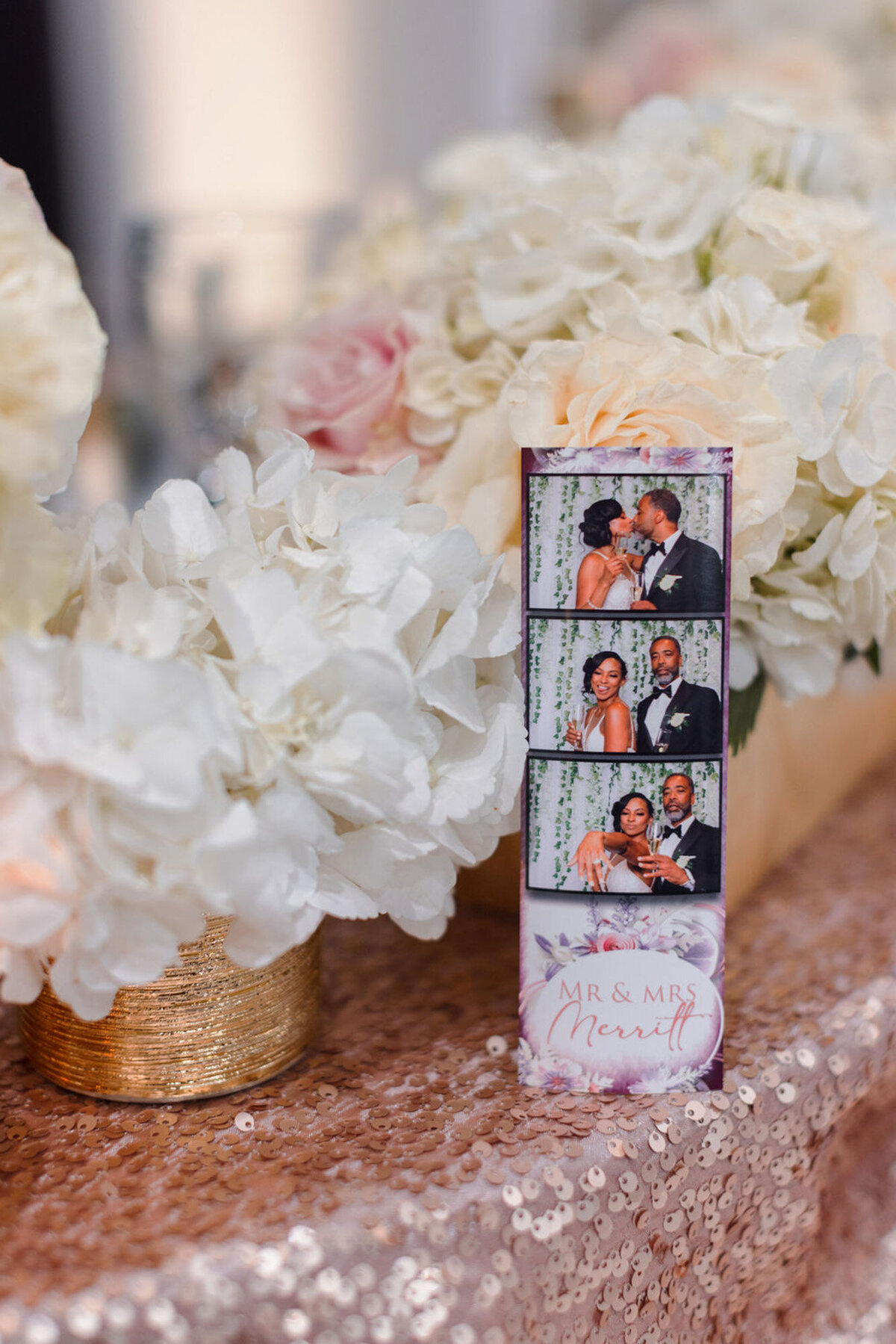 photo strip on pink table at wedding