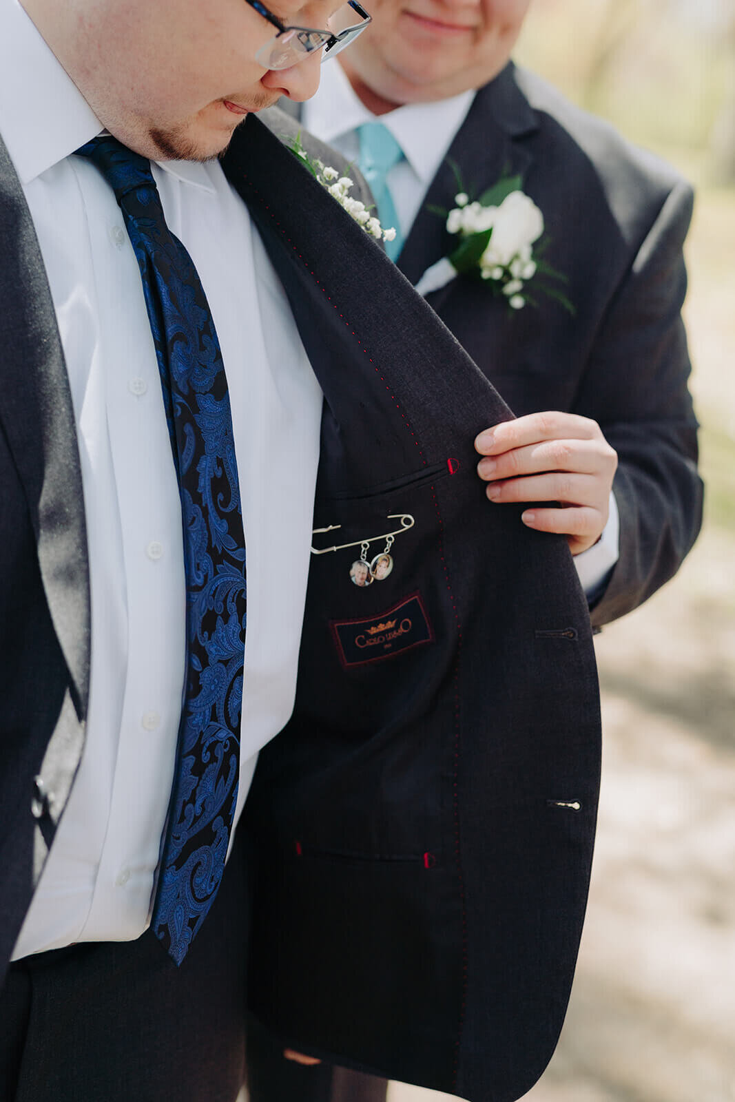 Man adjusting suit before wedding at Rochester NY