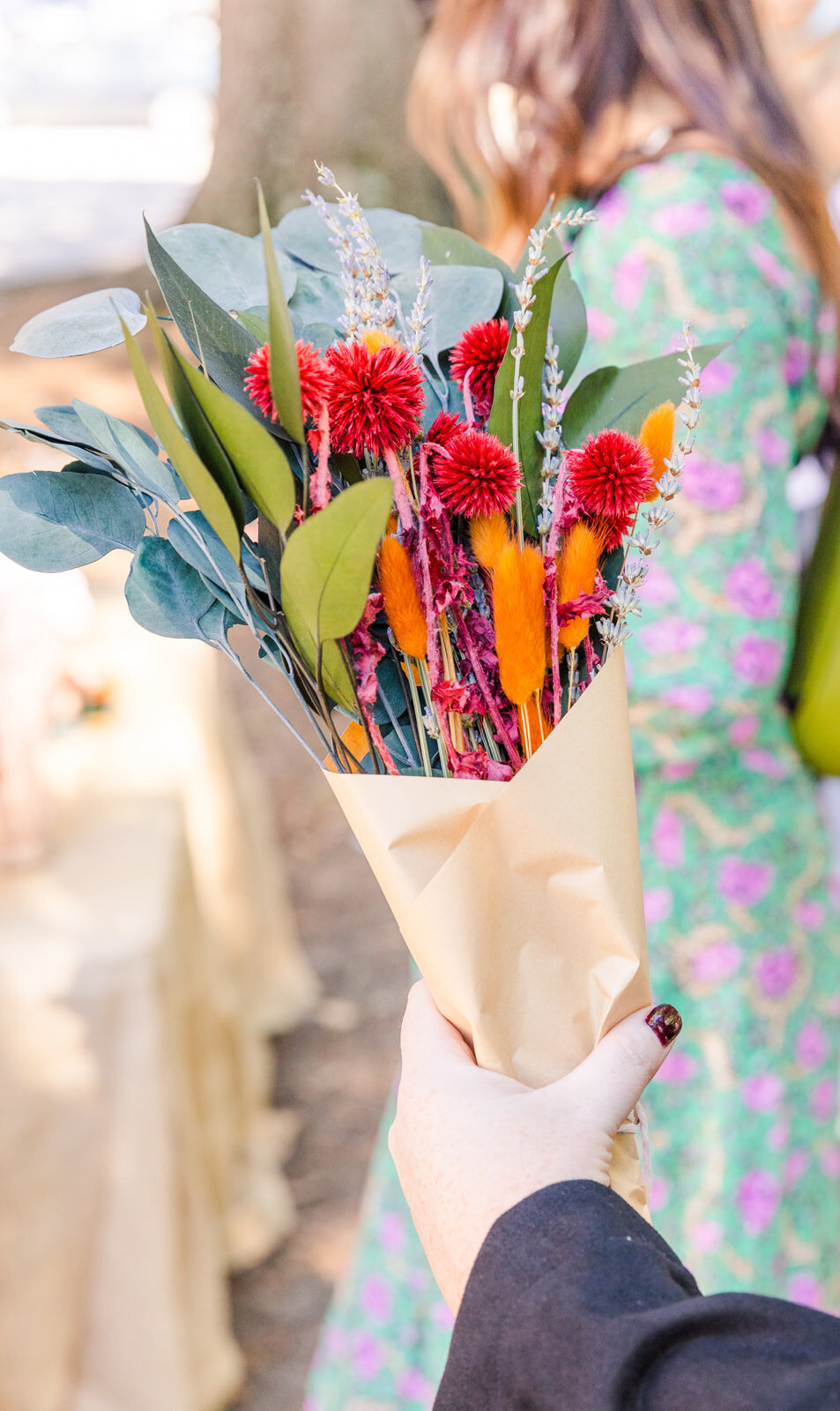 hand holder a flower arrangement