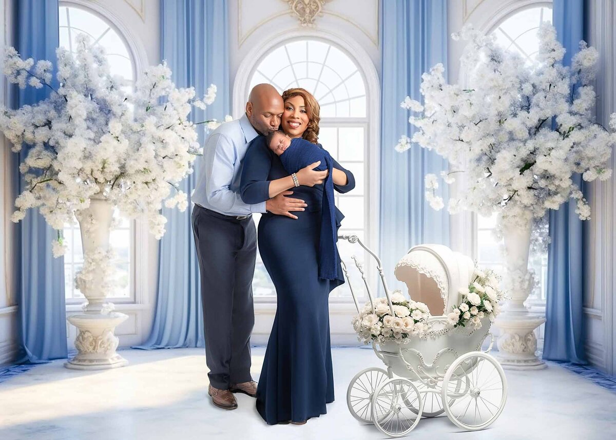 Birmingham maternity and newborn photographer – family studio portrait with mother, father, and newborn baby surrounded by elegant white floral décor and stroller