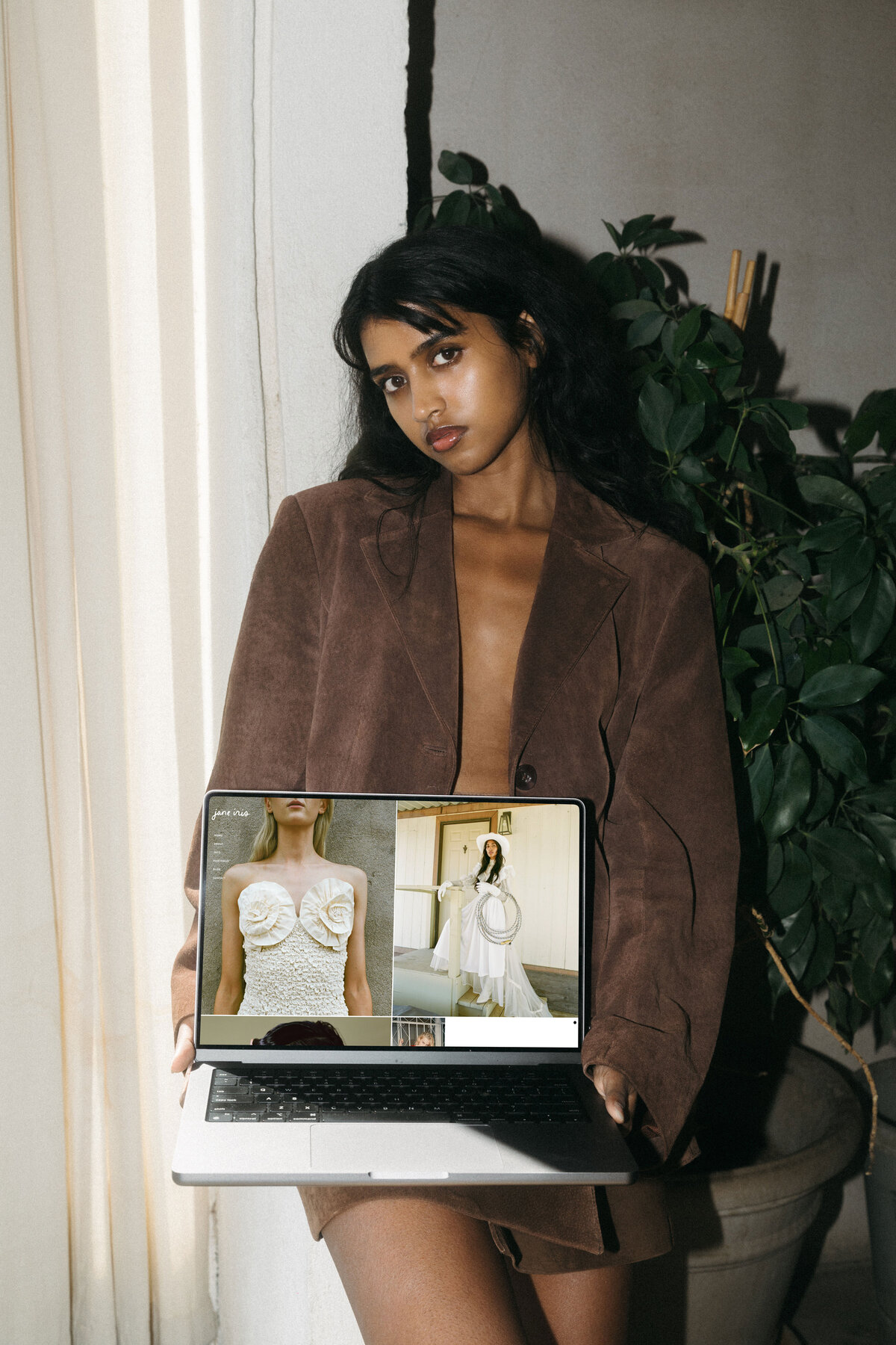 women holding laptop with Jane Iris website template