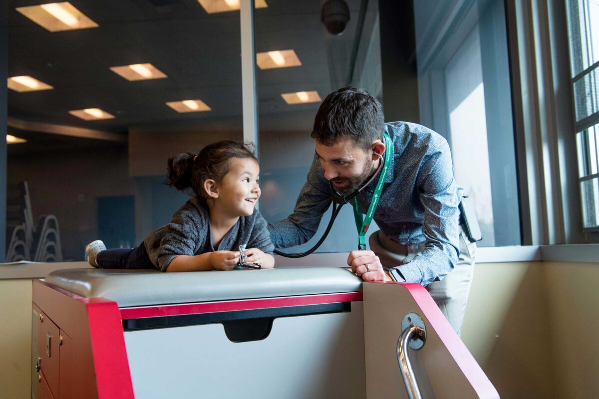 Doctor checks child at Father Joes Villages