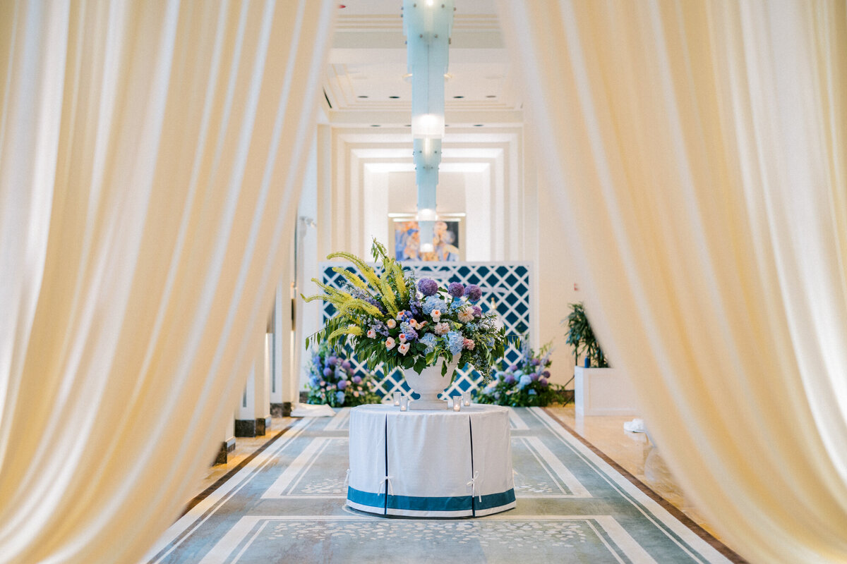 A luxurious wedding moment as guests enter a beautifully draped ballroom at The Peninsula Chicago.