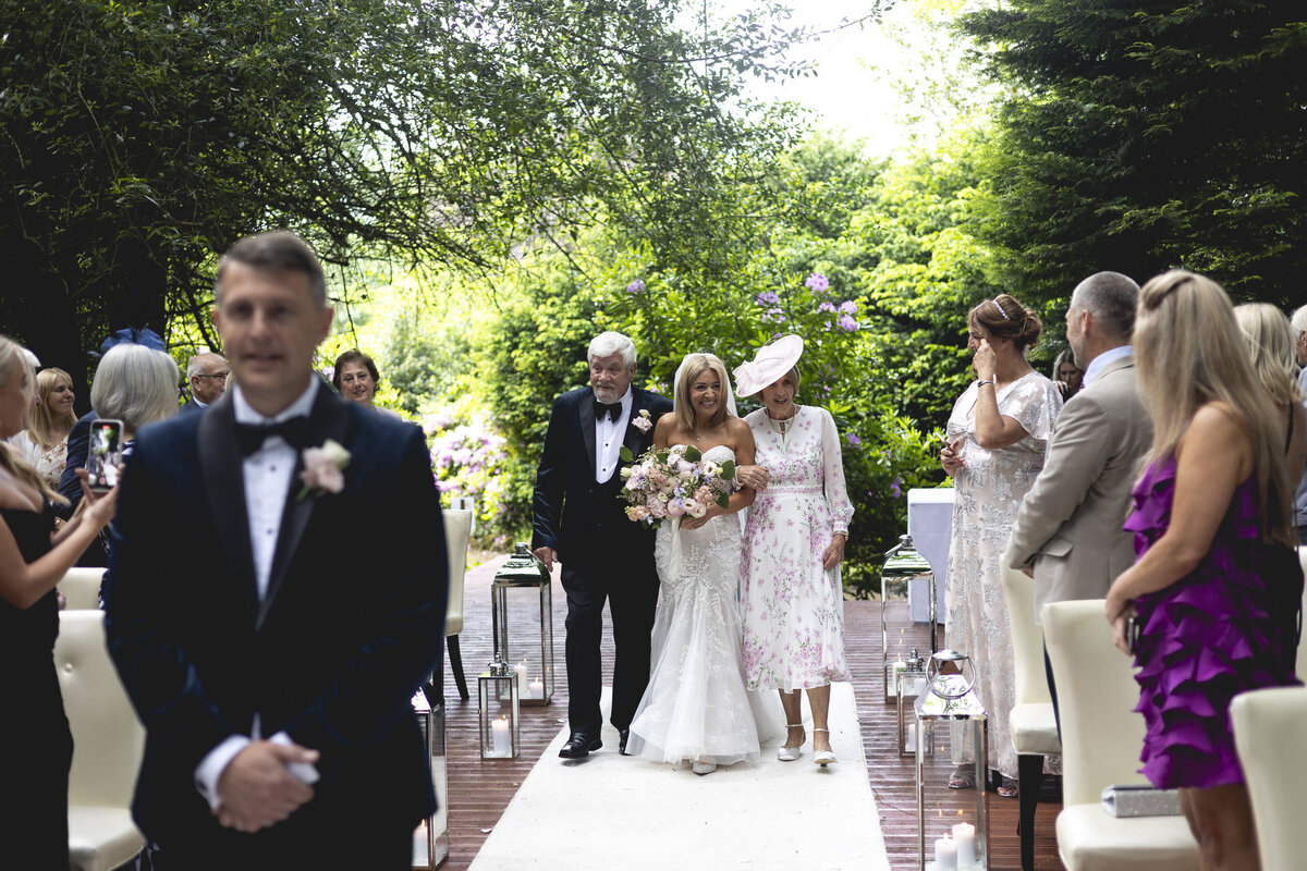 Jill being walked down the aisle by her parents
