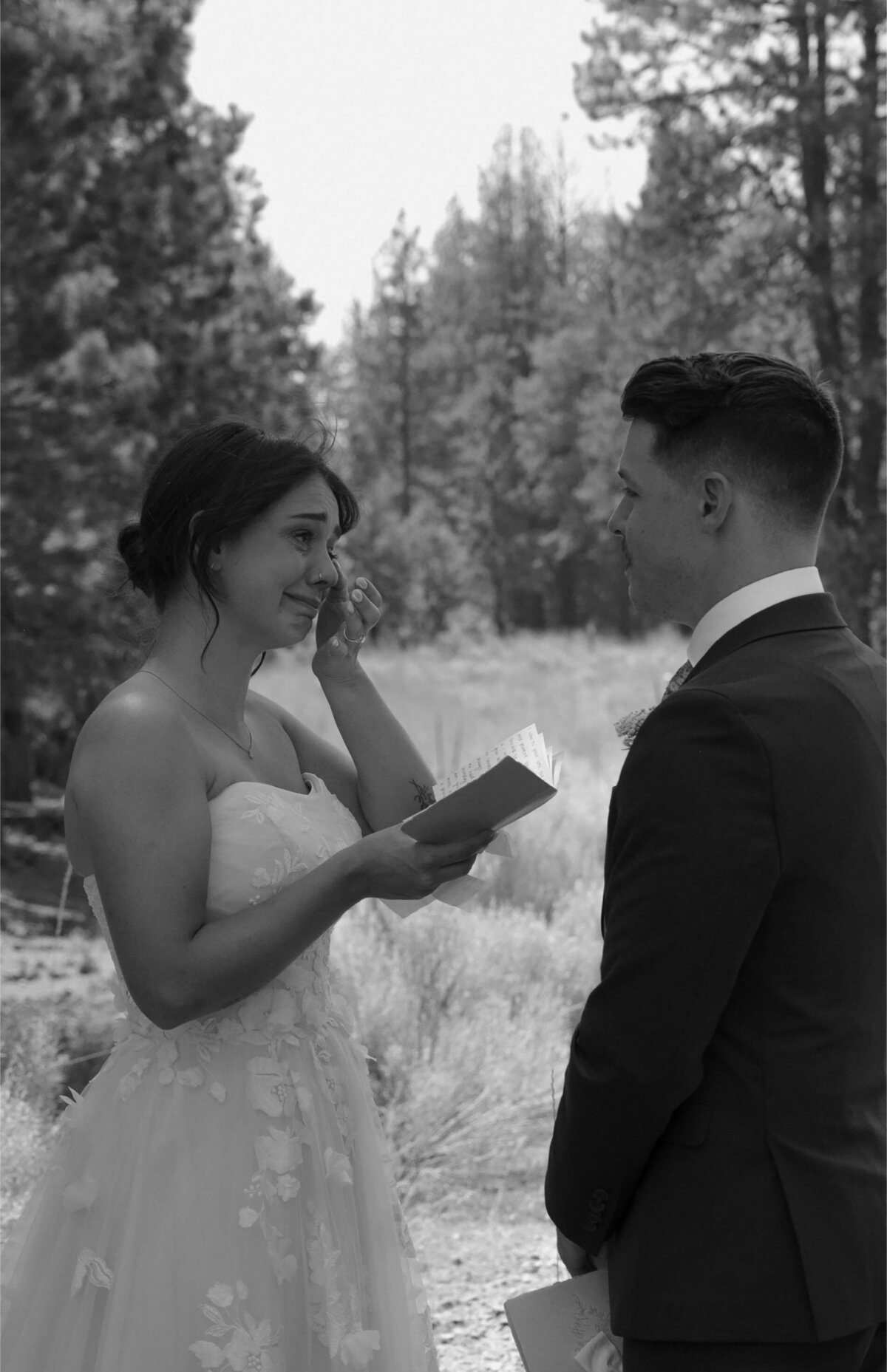 bride sheds tears while sharing vows with her partner in outdoor elopement in Bend, Oregon