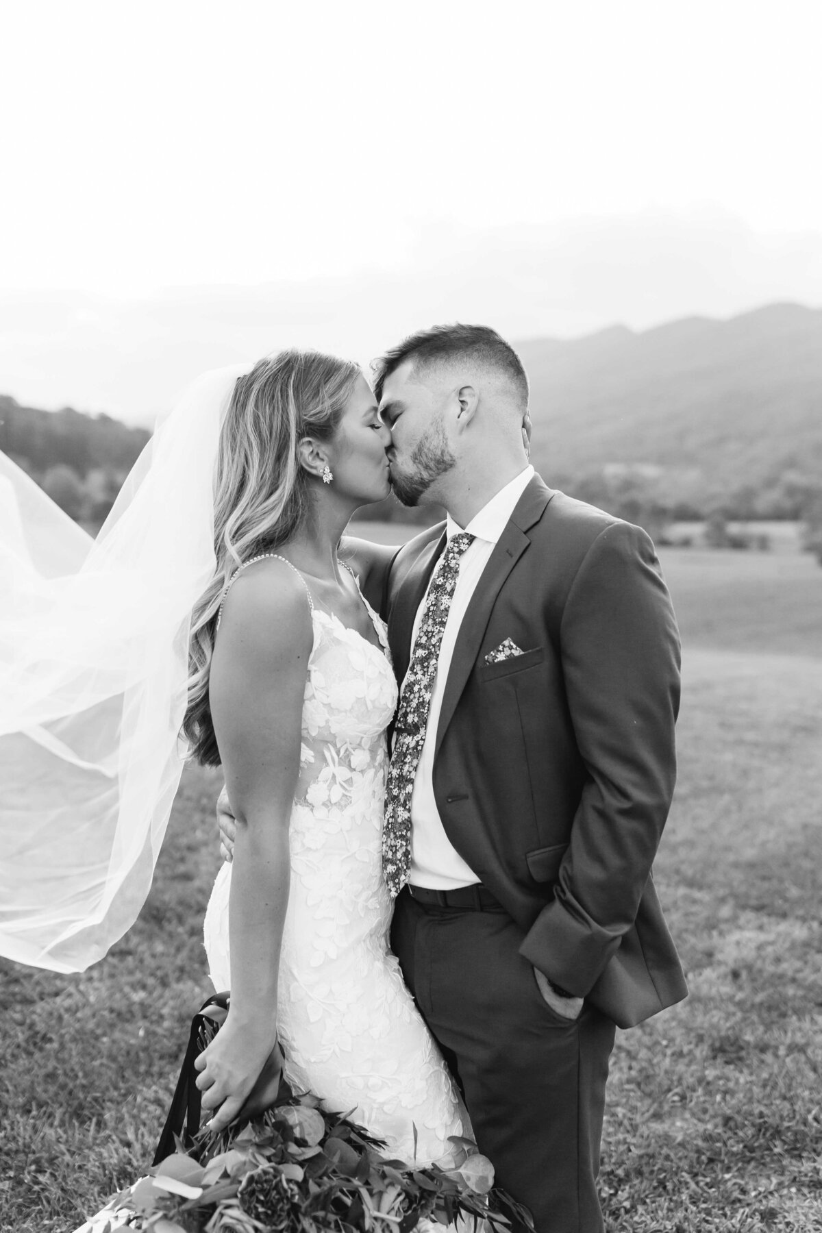 Black and white couple kiss at Crooked river wedding venue