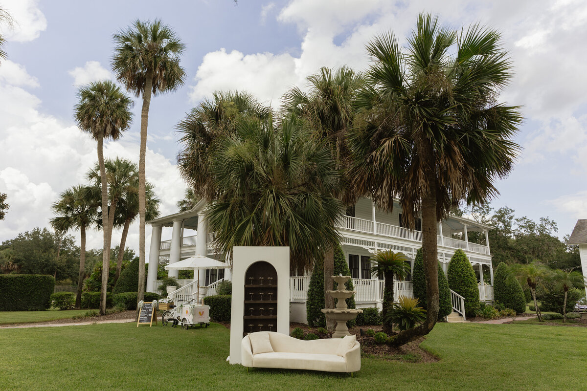Champagne shelf display with gold accents at a luxury backyard wedding in Umatilla, Florida