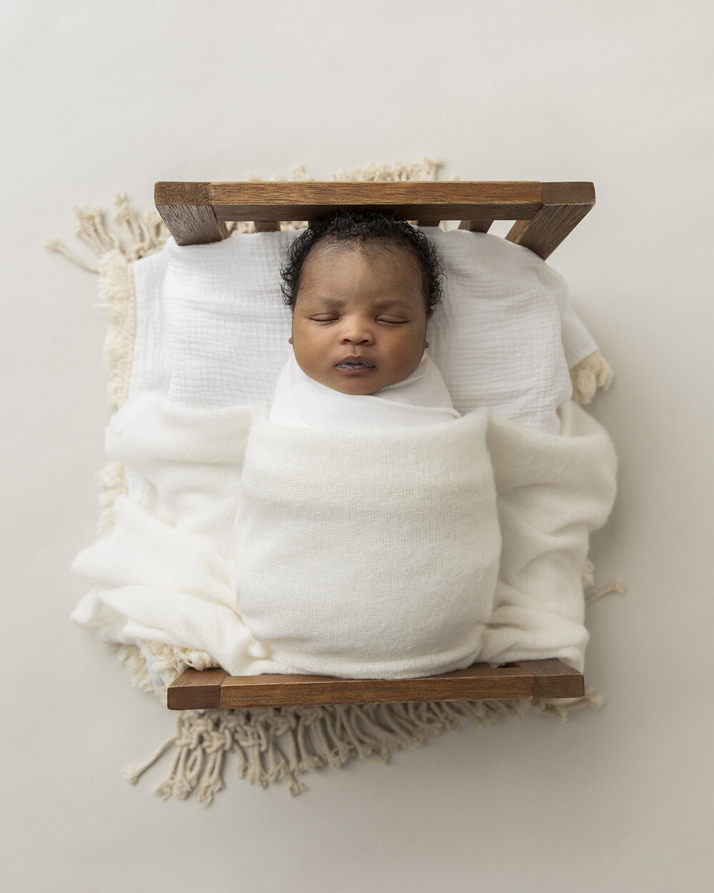 NEWBORN_BABYBOYINBABYWOODENBED