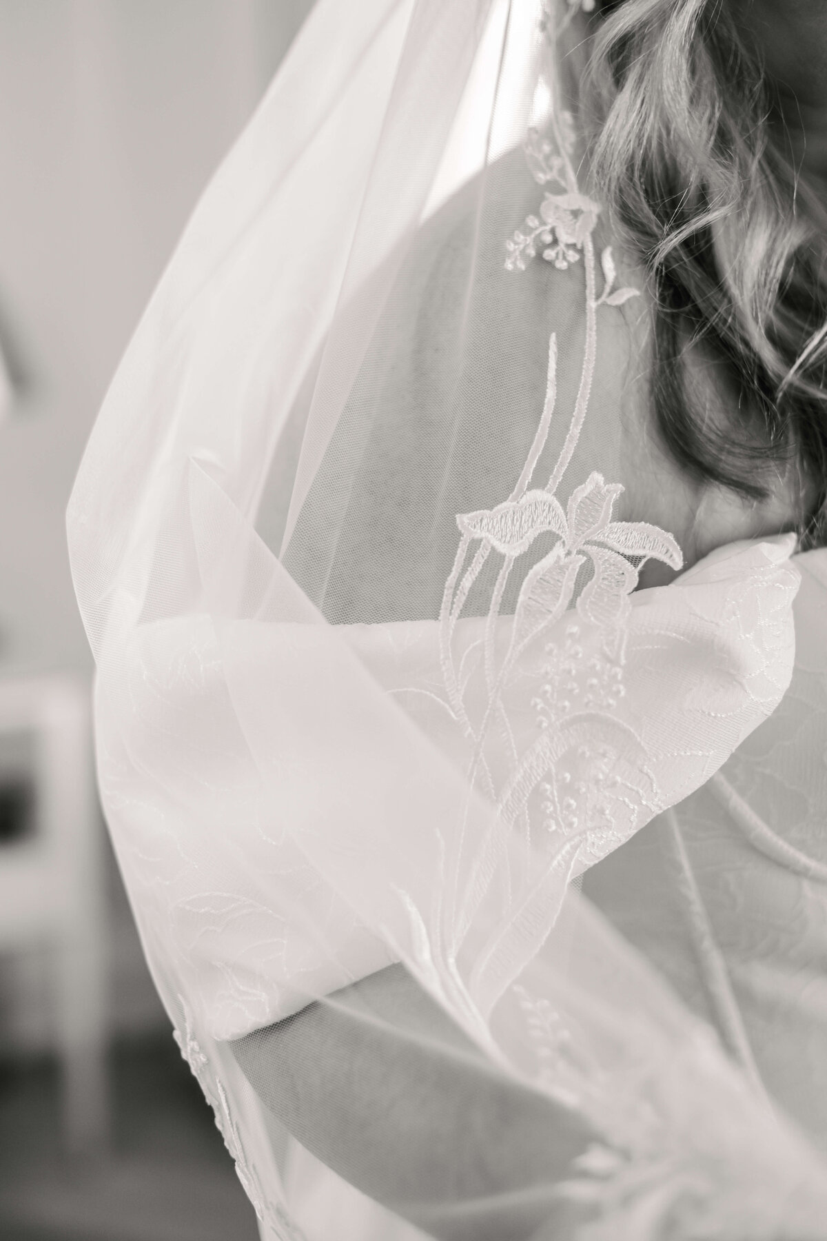 Detail of a bride in a wedding veil with embroidered lace