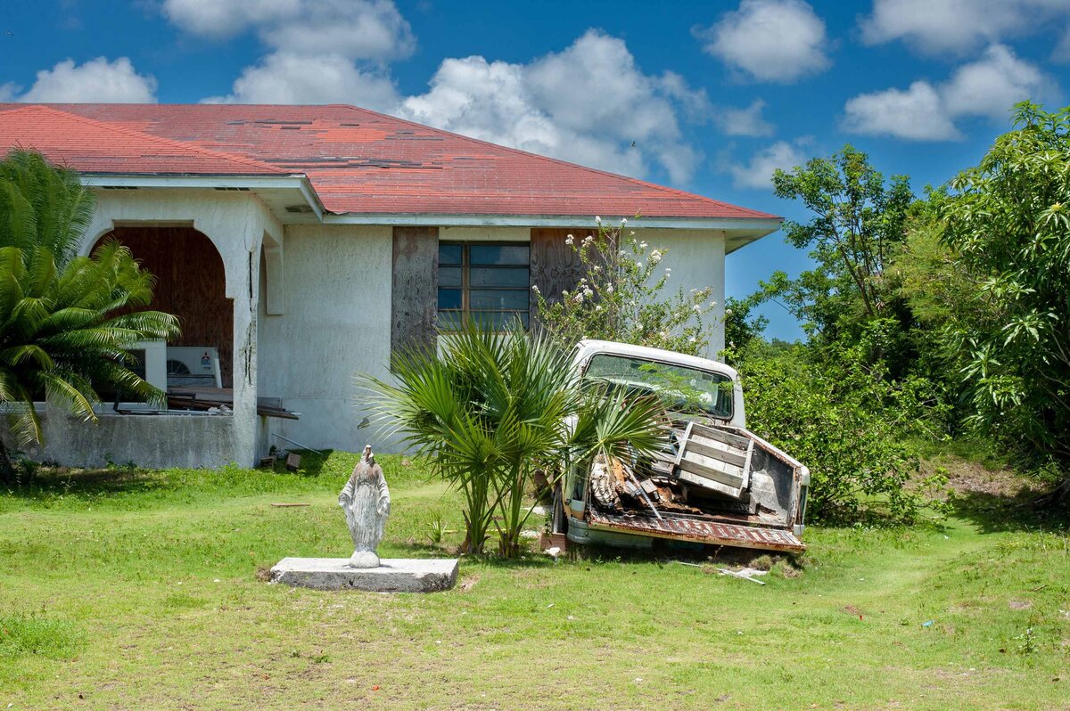 A statue of mary is headless on front lawn of house on Eleuthera Bahamas