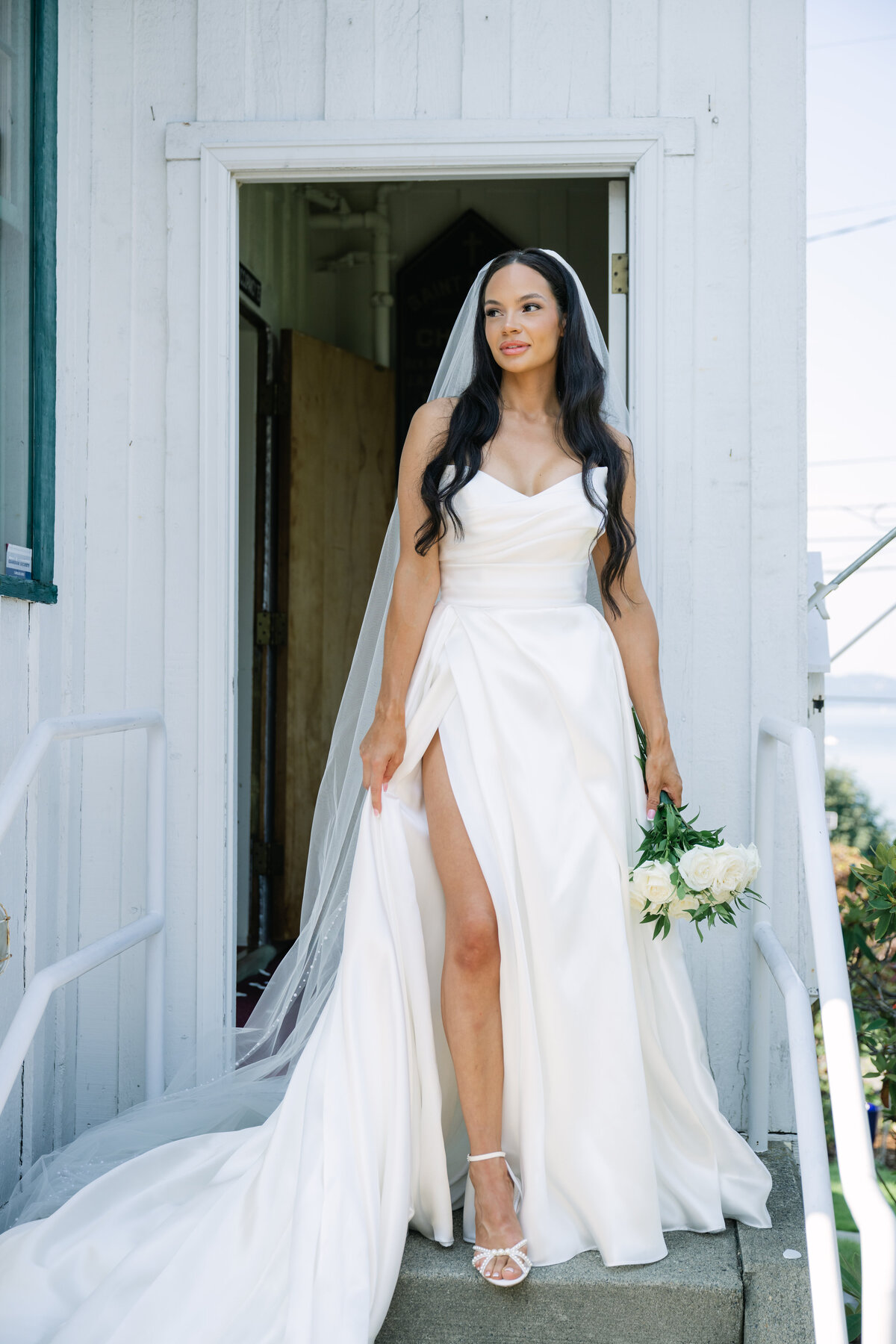 bride standing outside white chapel in tacoma washington