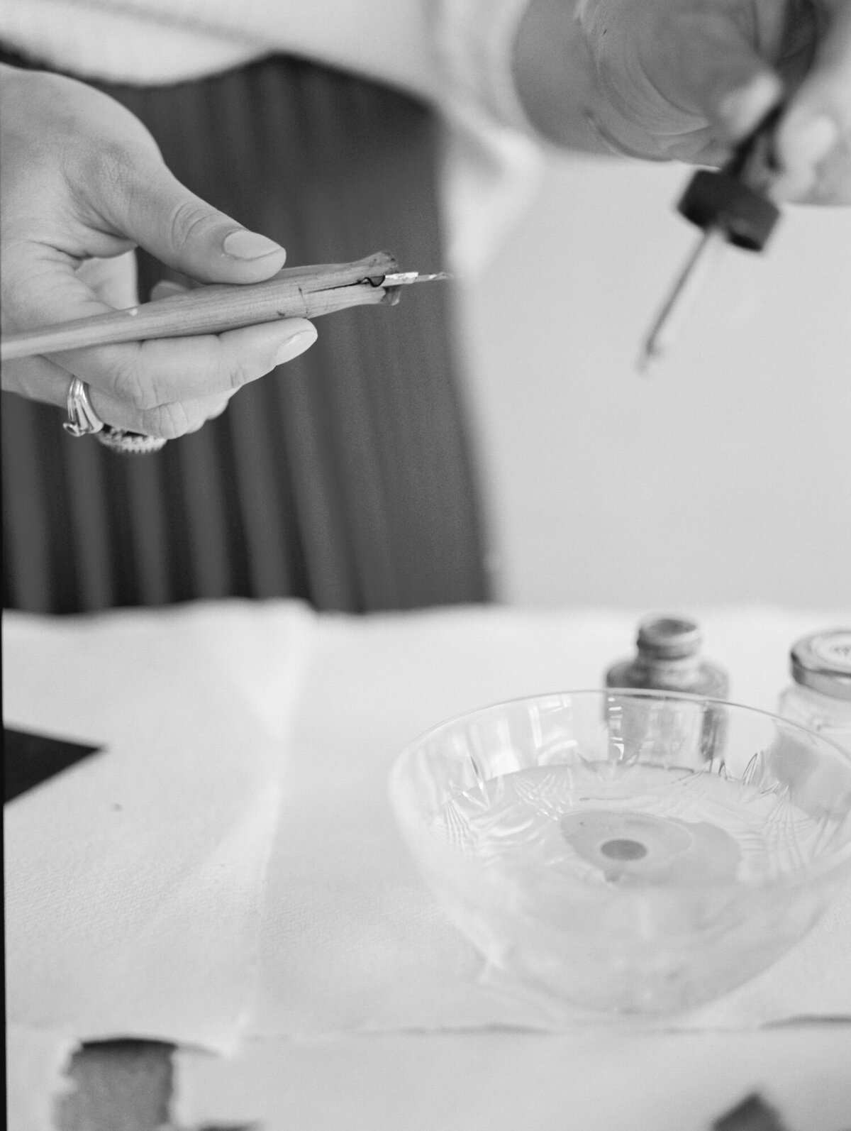 calligrapher with ink, water, pen, artist brand photography