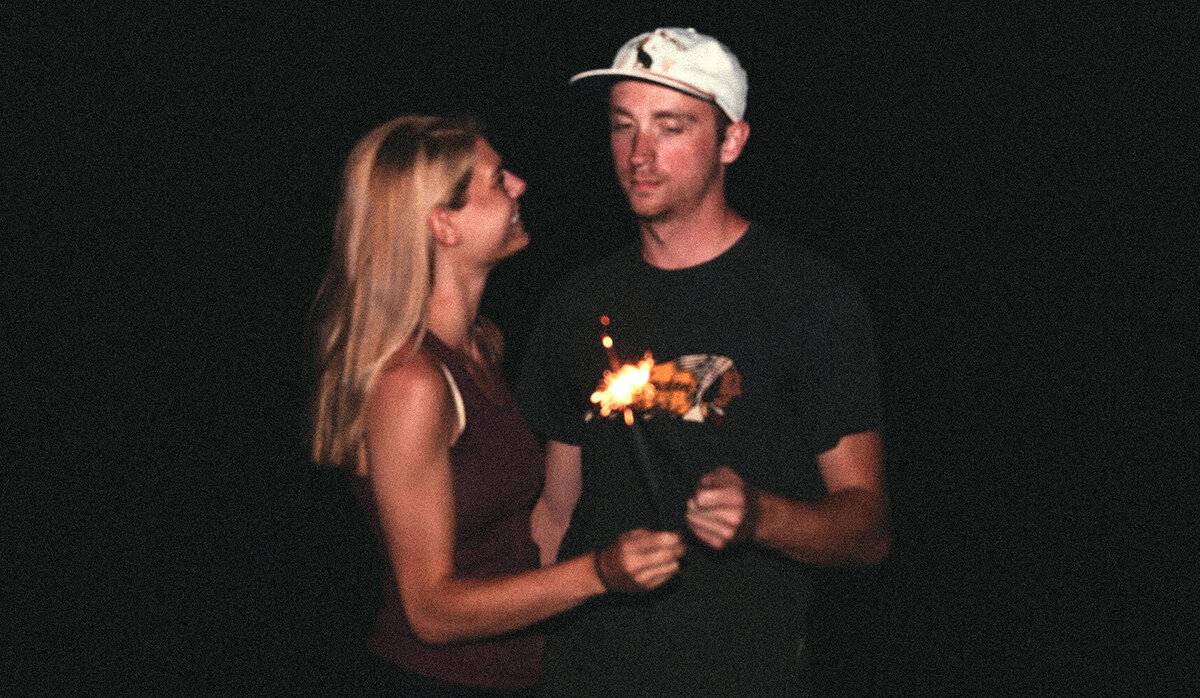 Alex and Alex holding sparklers at night