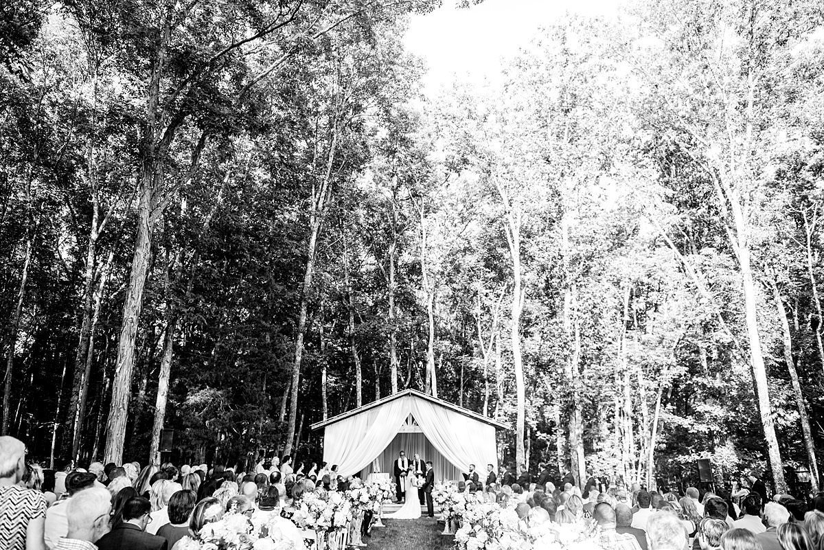 Black and white landscape photo of a ceremony at Saddlewood Farm