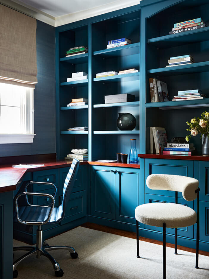 A navy blue home office in Concord, designed by an interior decorator in Boston, blending functionality and style.