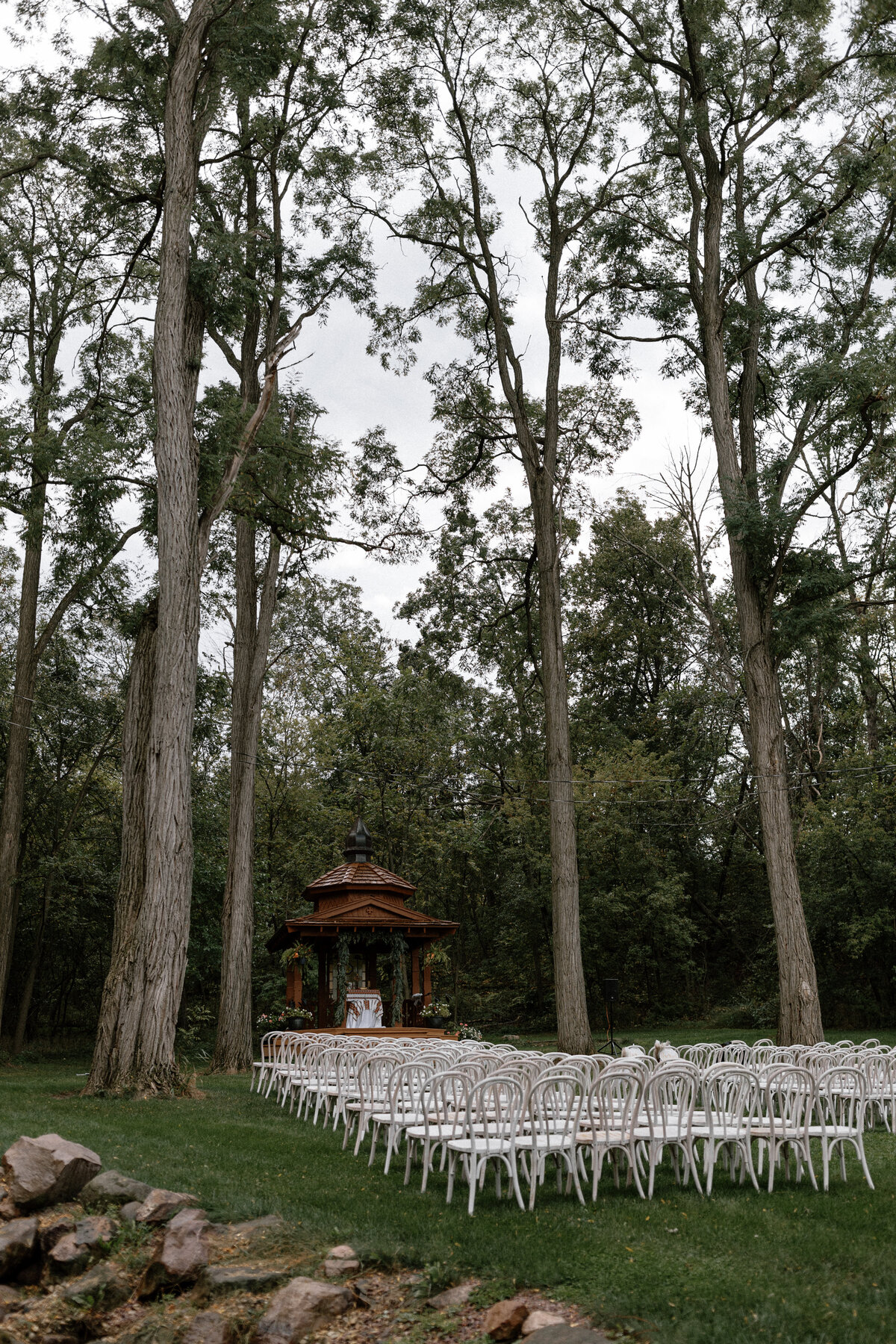 White bentwood chairs from Event Essentials for an ourdoor wedding ceremony in Wisconsin