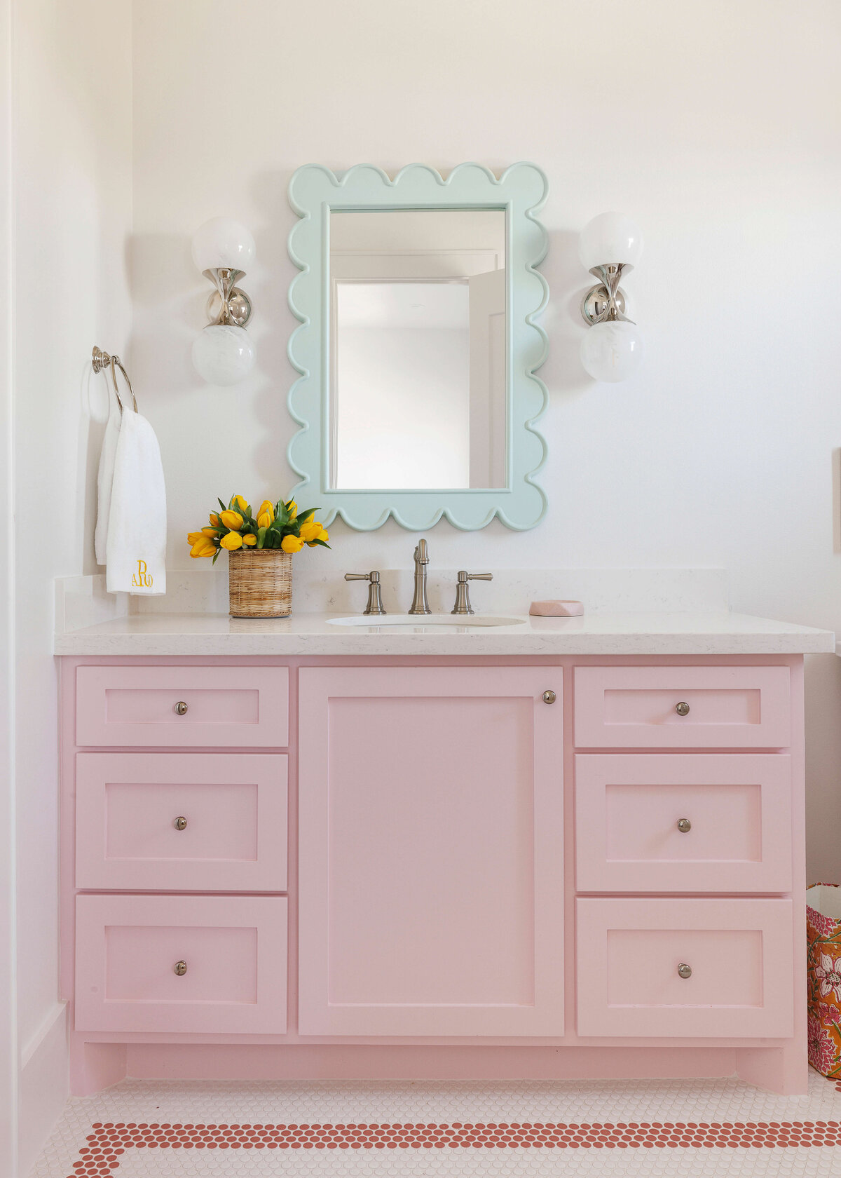 oyster creek studios lighthouse on the lake pink vanity with blue mirror in bathroom