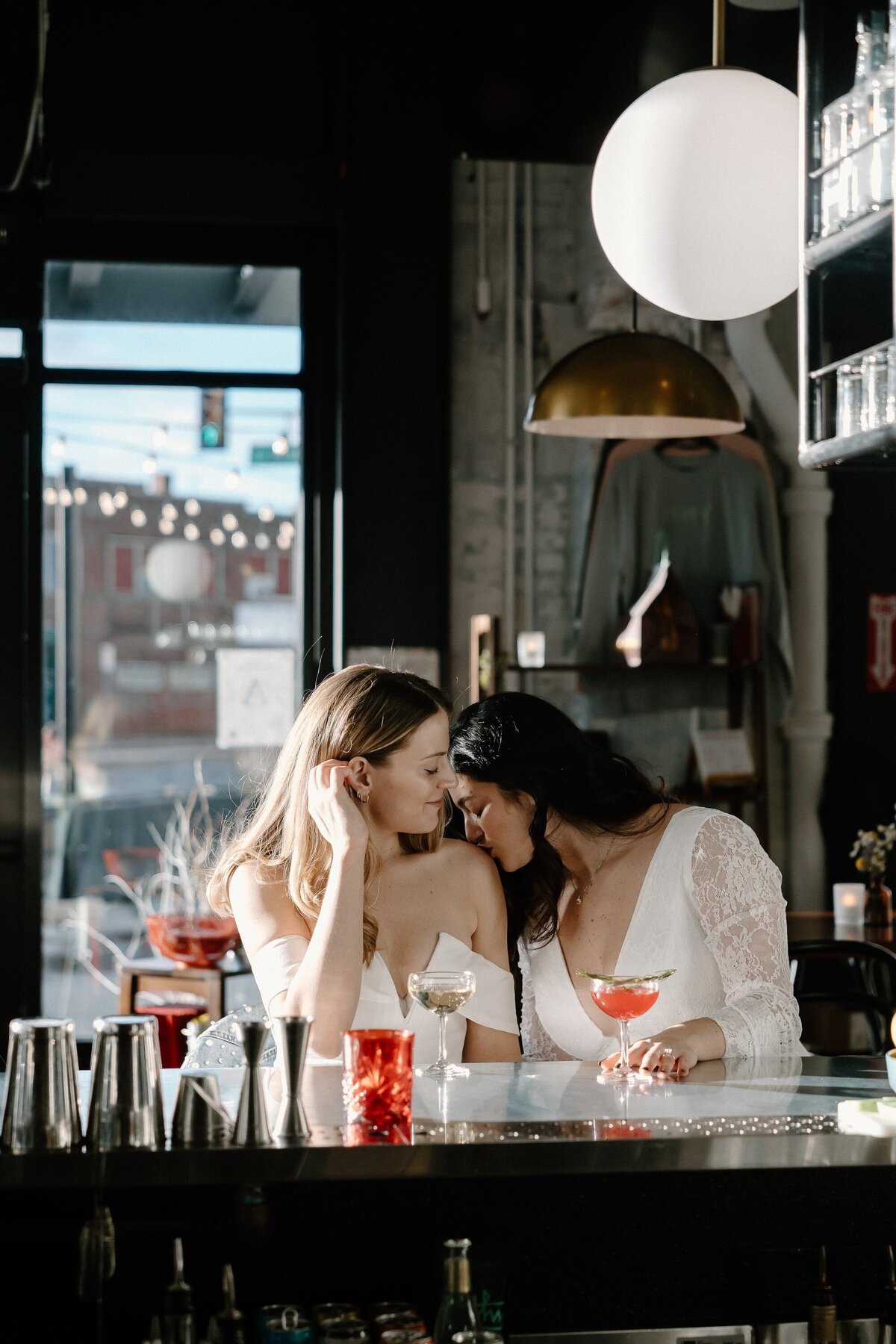 engaged female couple at bar with drinks