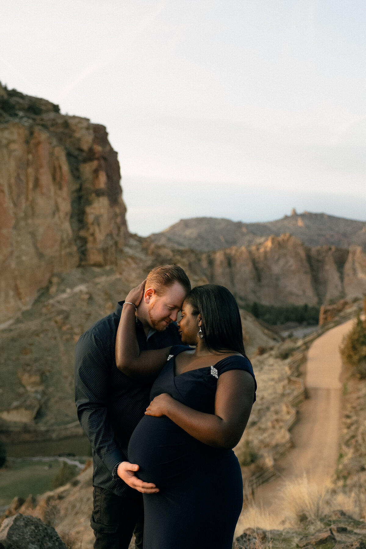 Smith Rock Oregon Maternity Session at Golden Hour with Couple Embracing Among Canyon Views