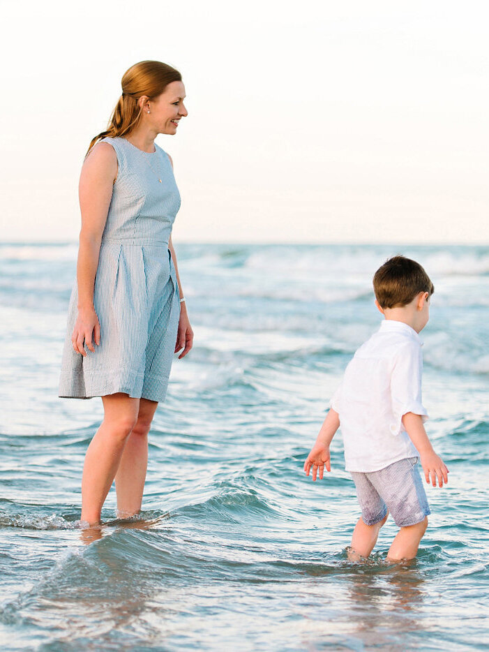 Mother plays with her son by the beach at sunset during the Myrtle Beach family session.