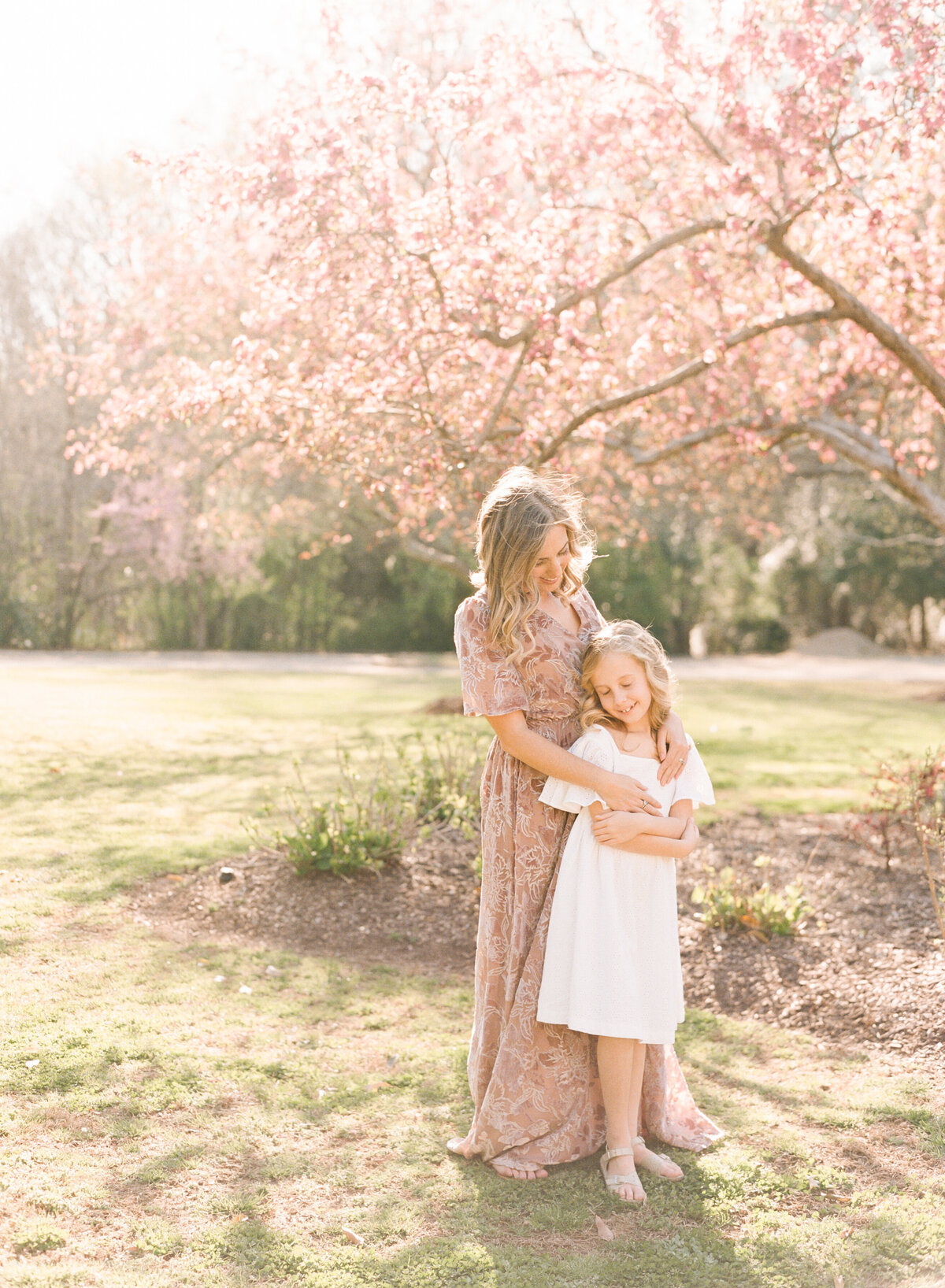 Mom holds her daughter close and snuggles her at The Sutherland in Wake Forest. Image by Raleigh maternity photographer A.J. Dunlap Photography.