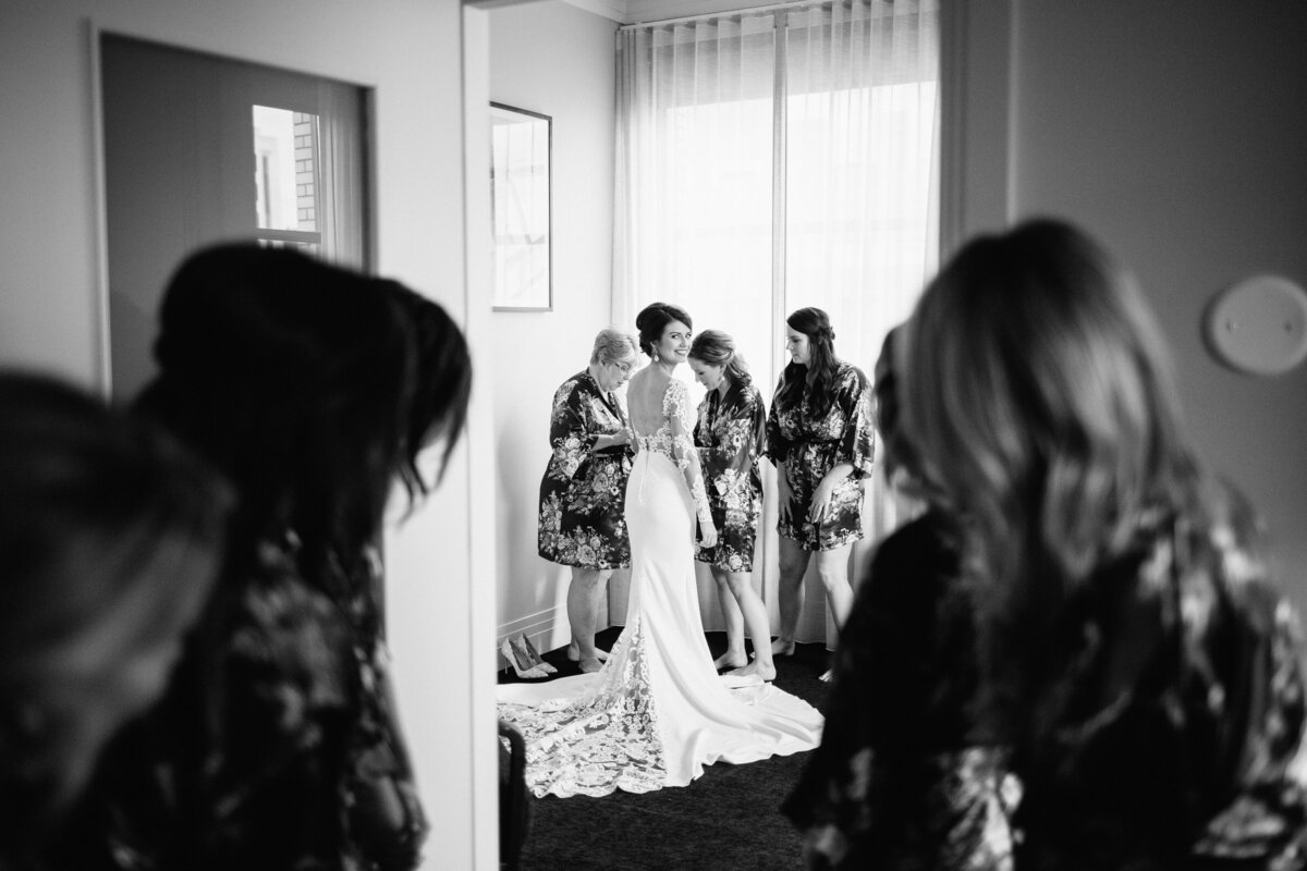 Bride getting ready with her girls peeking