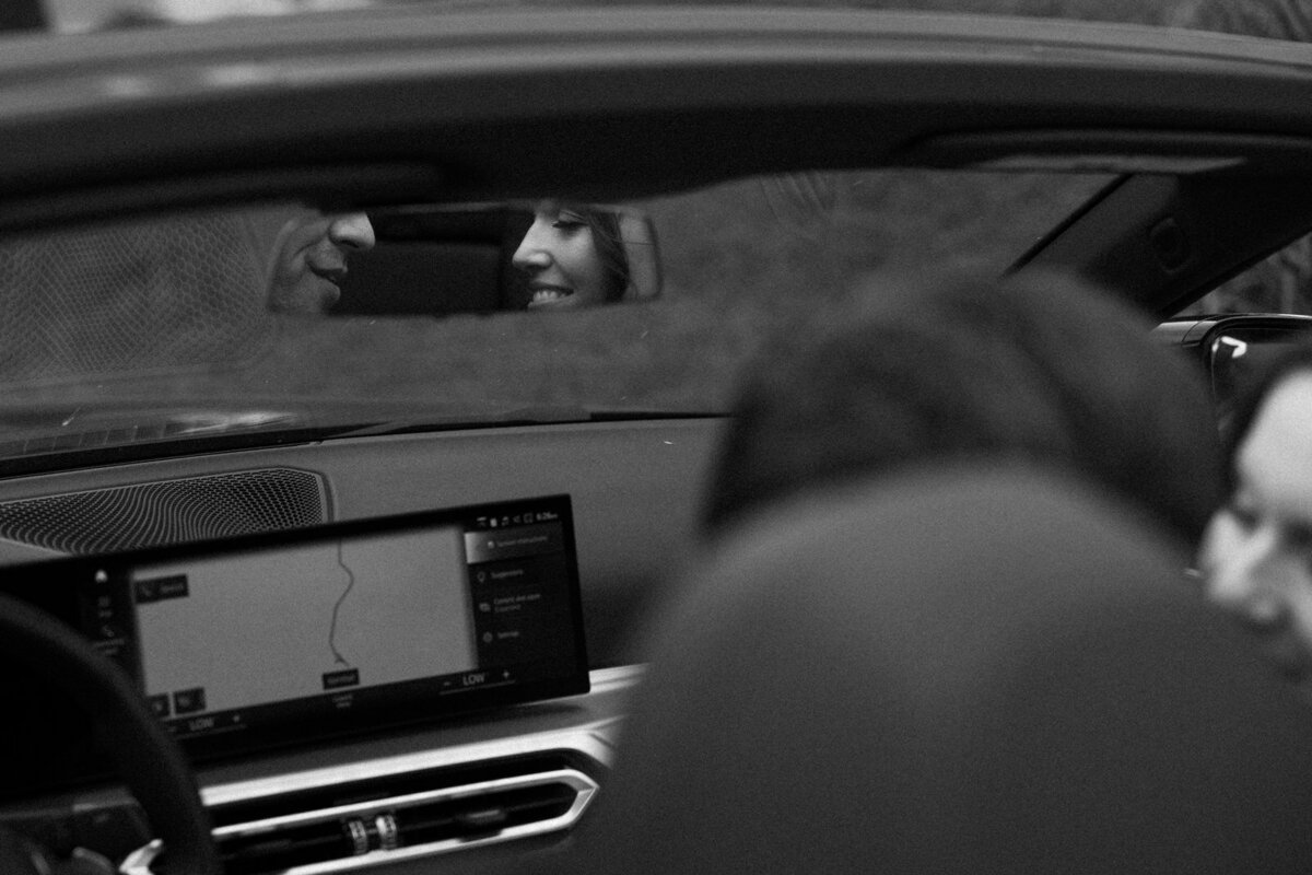 Bride and Groom stealing a kiss in their getaway car in Asheville NC, captured by Andrea-Marie Photography