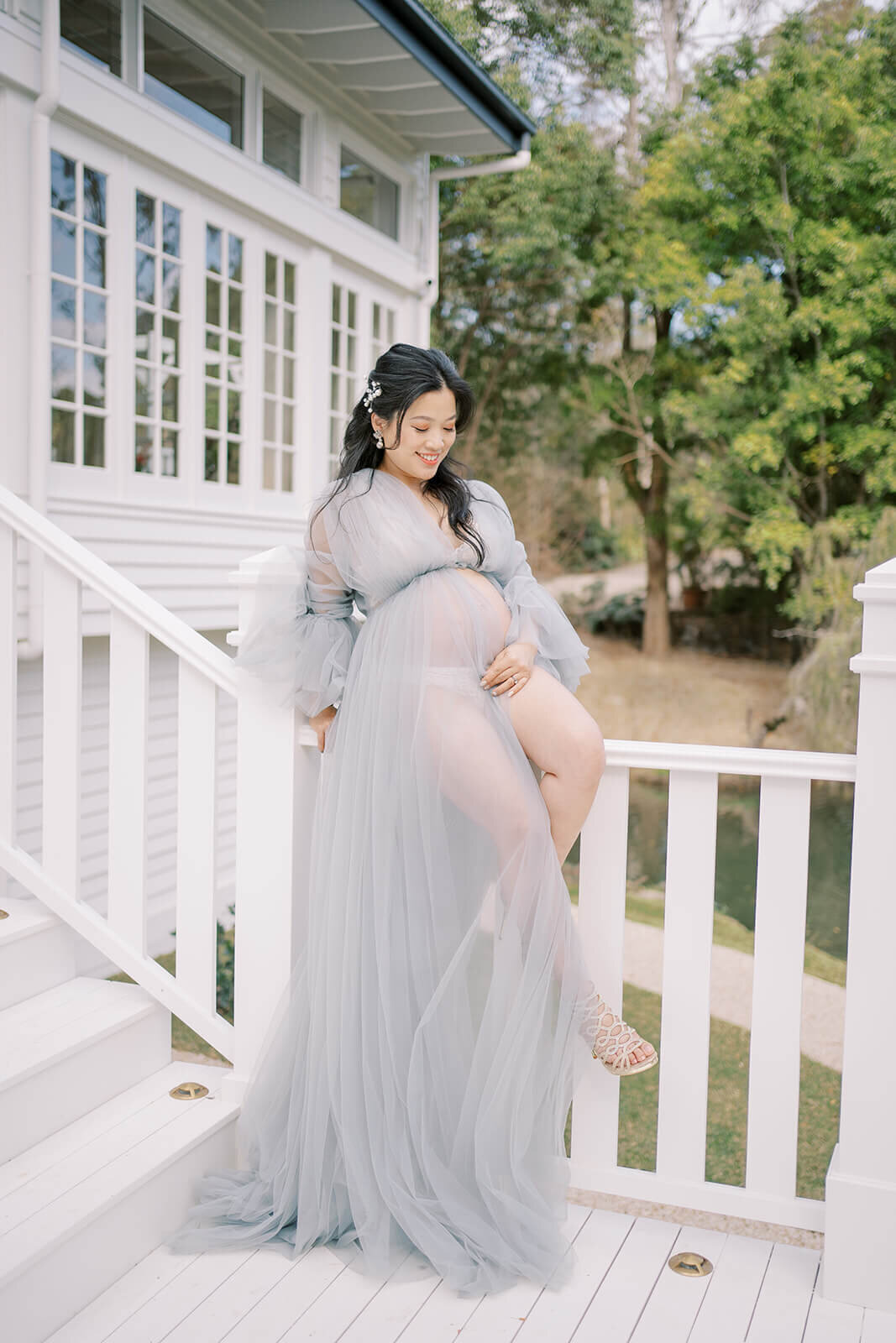Cherish the anticipation of a baby's arrival with a mum in a stunning blue tulle gown at Gold Coast's Kwila Lodge.