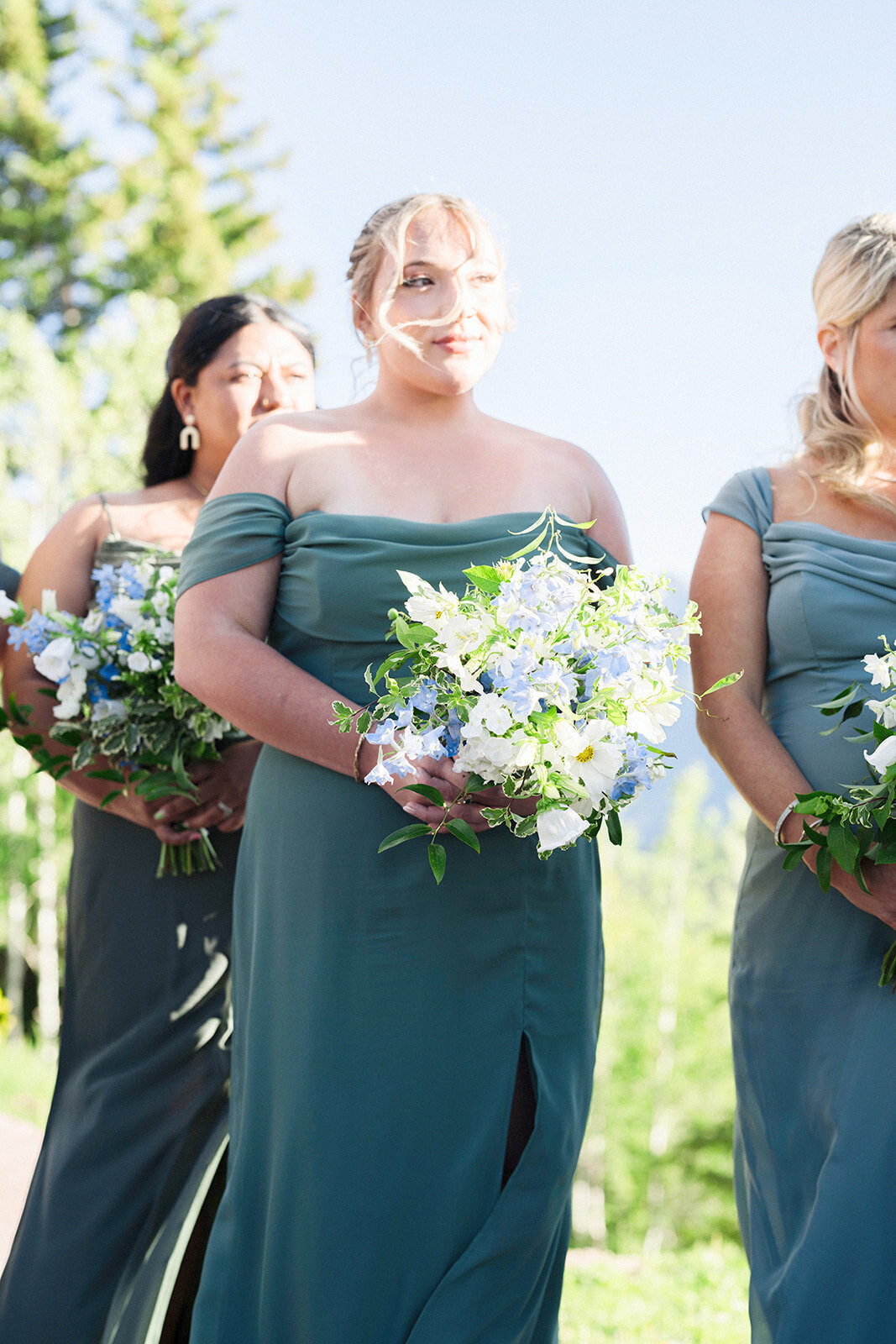 bridesmaids-holding-flowers-teal-dress