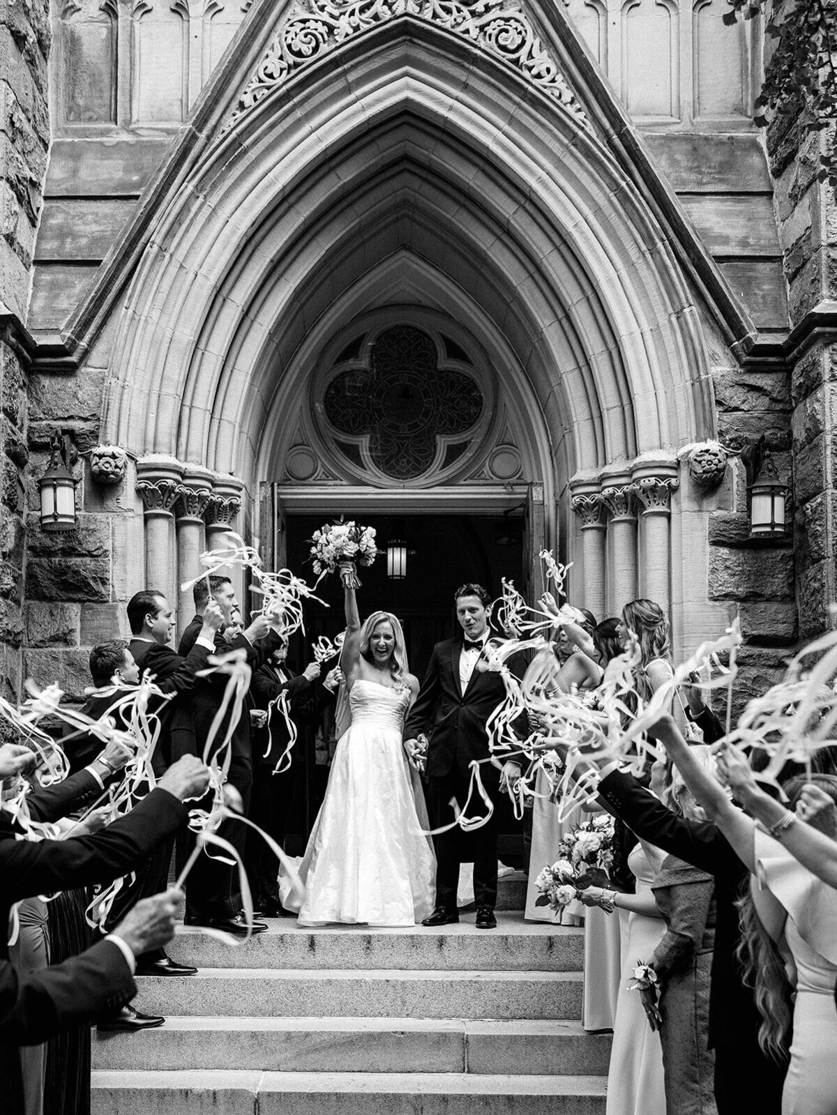 Couple exit St Mary's Parish surrounded by their loved ones