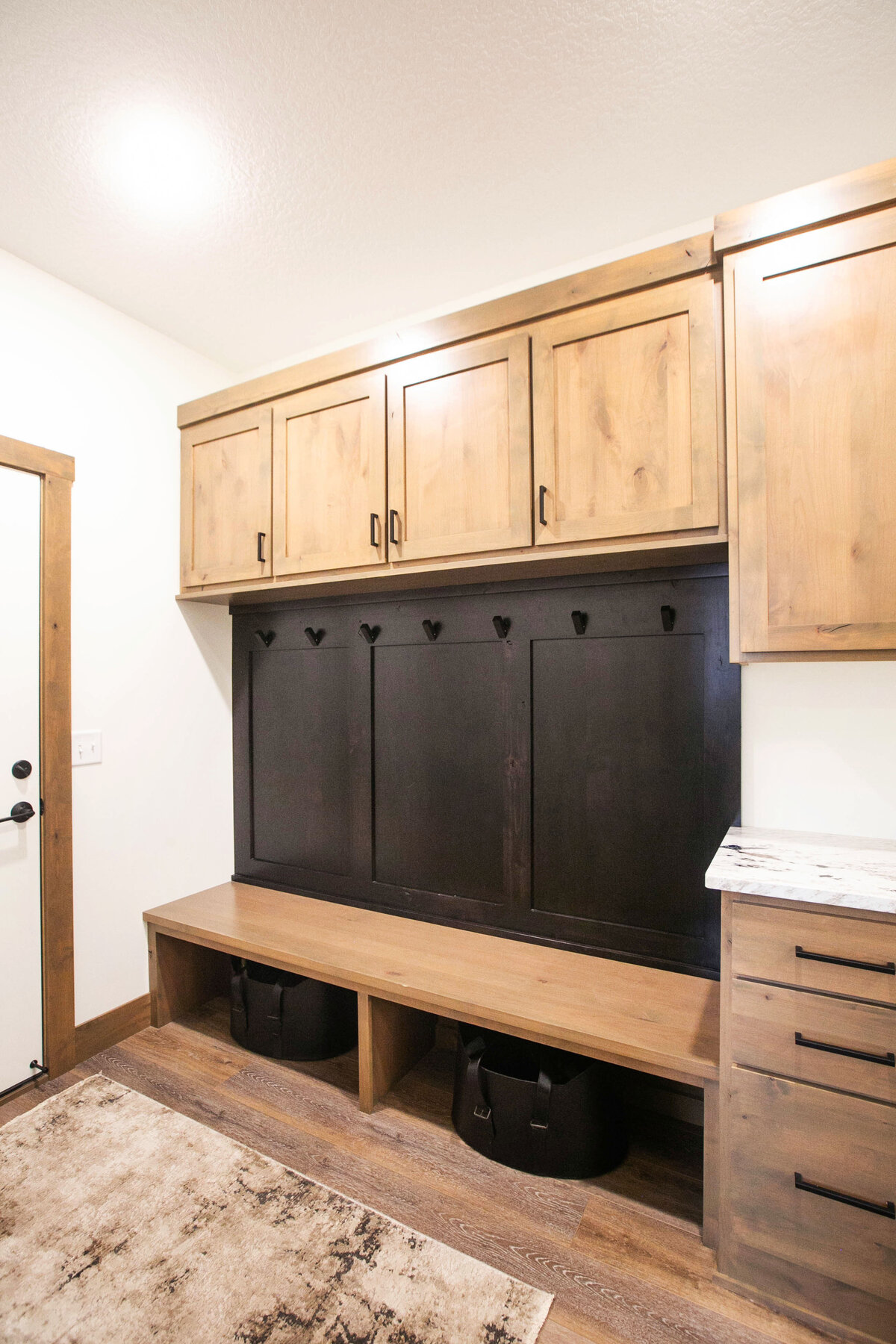 Back Entry with wood flooring and built in lockers n a custom-built Elk River home