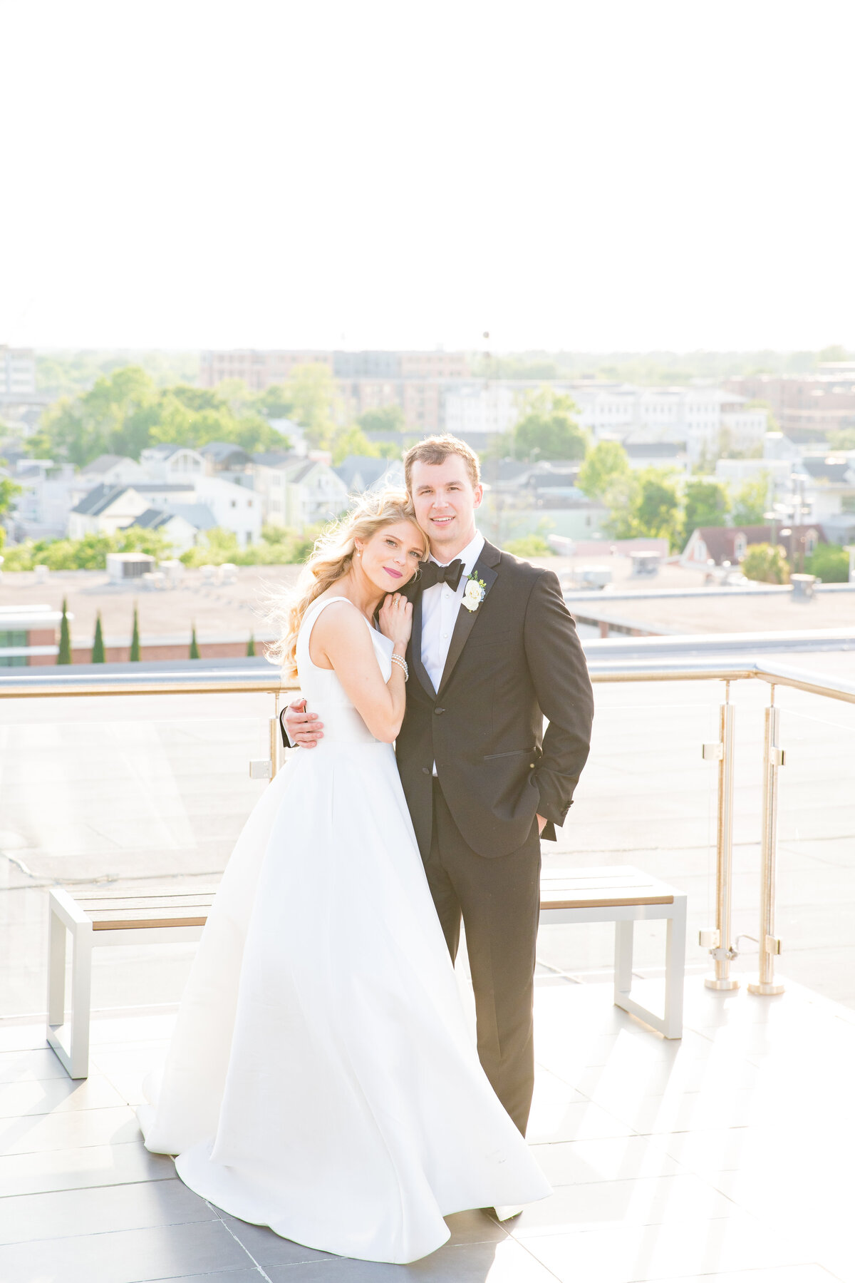 Rooftop portrait of the bride and groom on their wedding day by Charleston, SC wedding photographer Dana Cubbage.