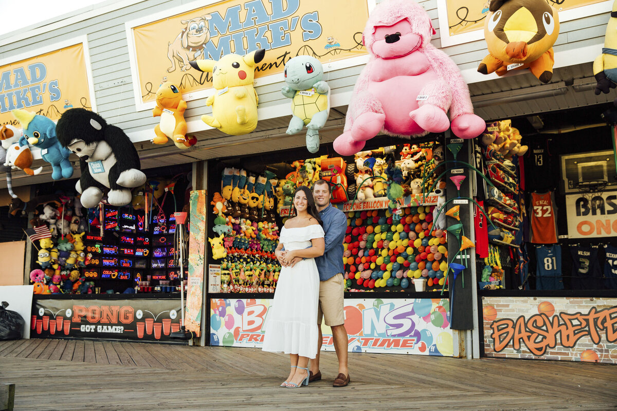 Couple hugging during summer engagement photo in Point Pleasant New Jersey