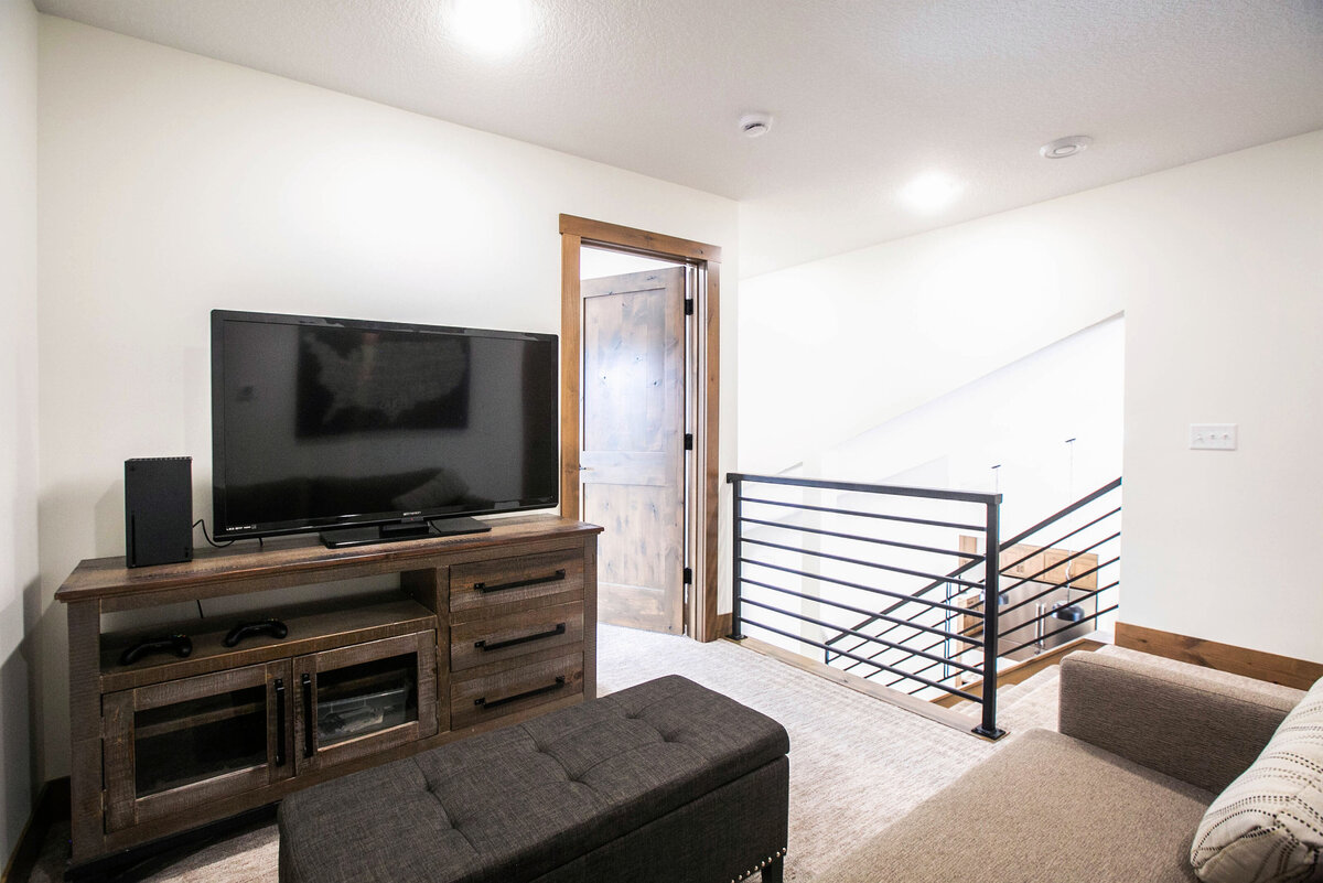 Open Concept loft with neutral tones and modern accents in custom Elk RIver home