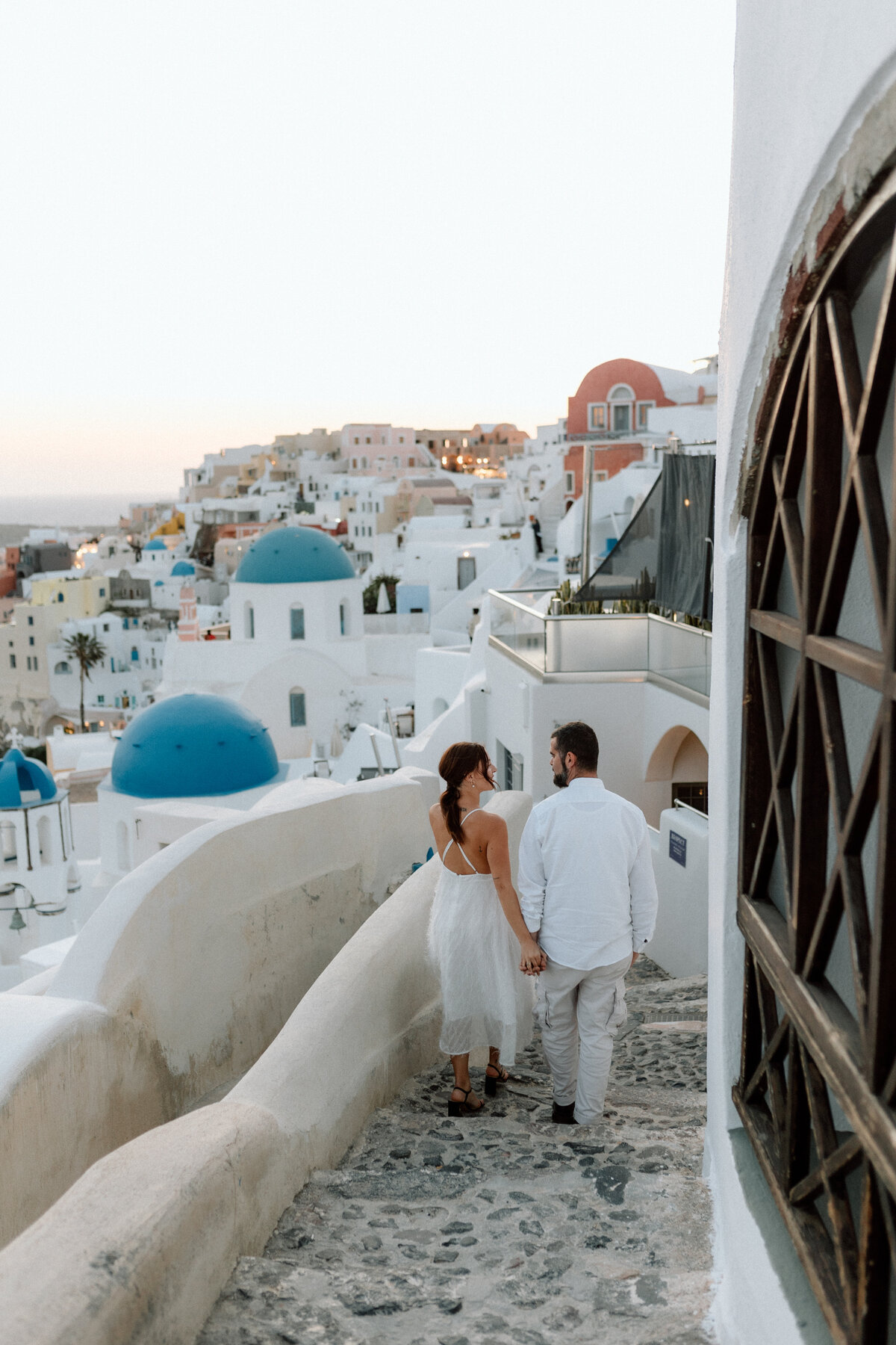 Couple during sunset portraits in Santorini Greece