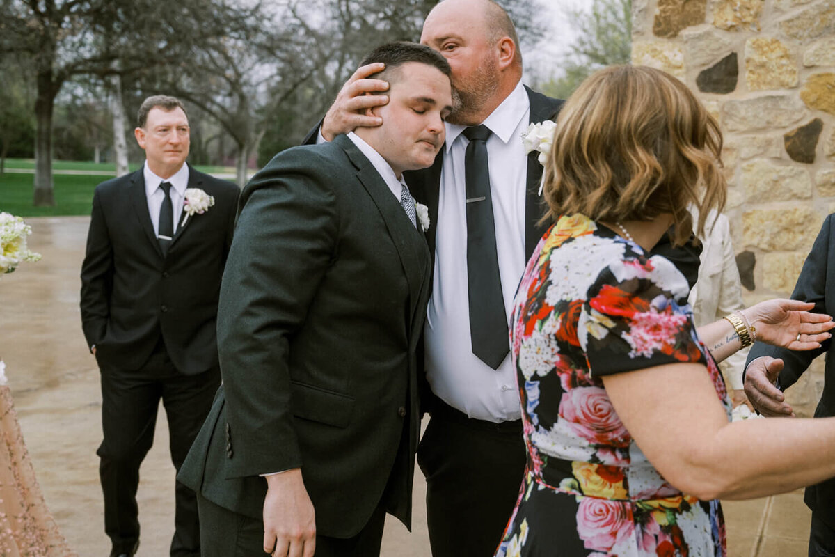 father-kissing-groom-on-forehead