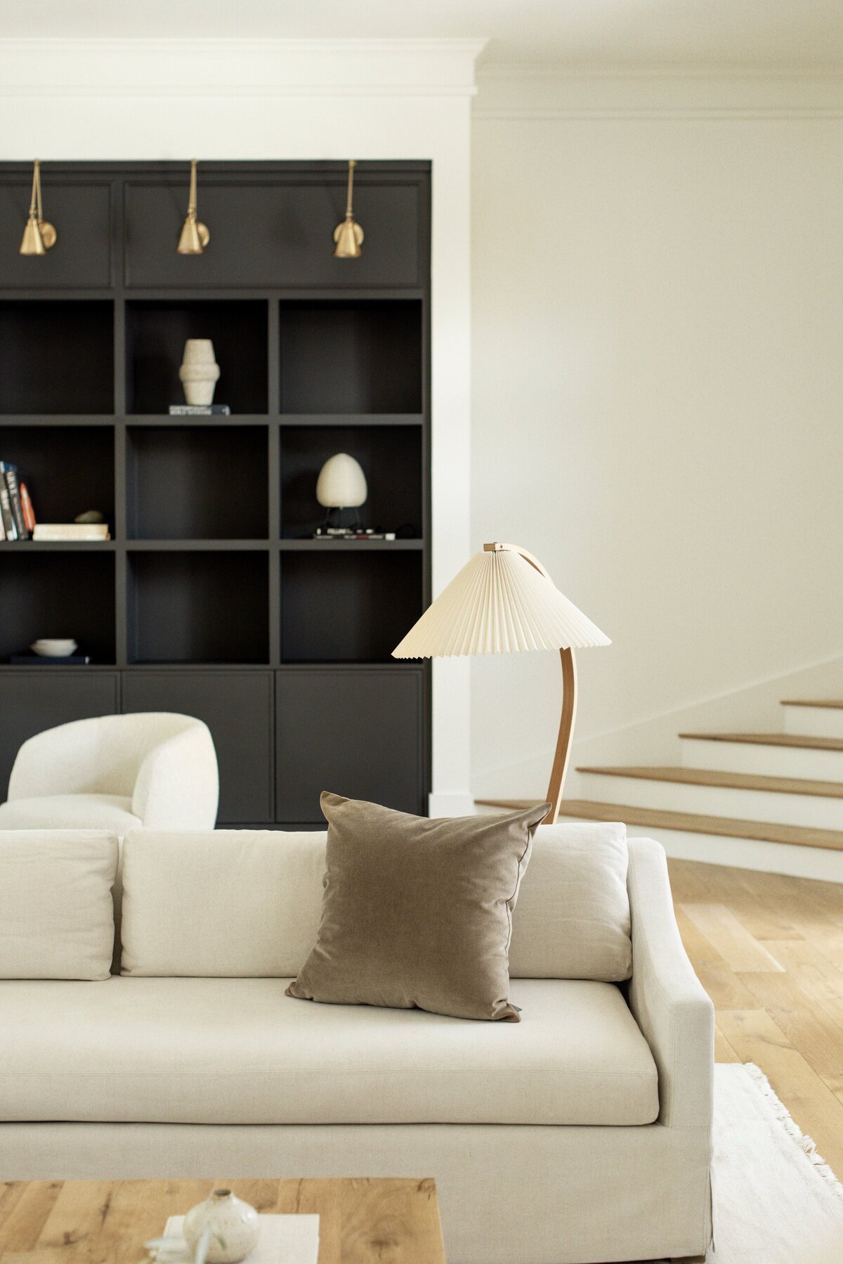 house-franc-toro-canyon-westlake-remodel-renovation-living-room-plaster-fireplace-slipcover-sofas-oak-wood-coffee-table-patina-vintage-caprani-floor-lamp-navy-built-in-cabinetry-library-moody-historic-neighborhood-austin-texas