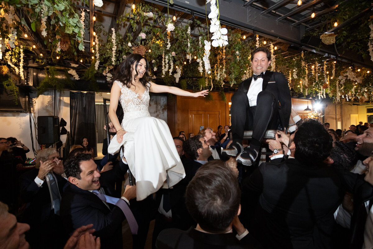 sarah and mark are lifted during the horah